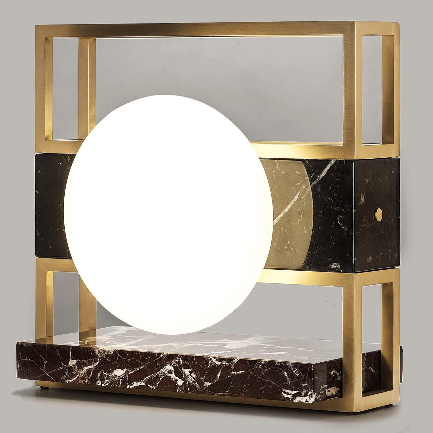 Simple yet detailed, this exceptional light sculpture by Hagit-Pincovici features an orb-shaped light embedded within a square frame. The hand-blown Murano glass orb stands out against the black Carrara marble and a metallic brass frame treated with