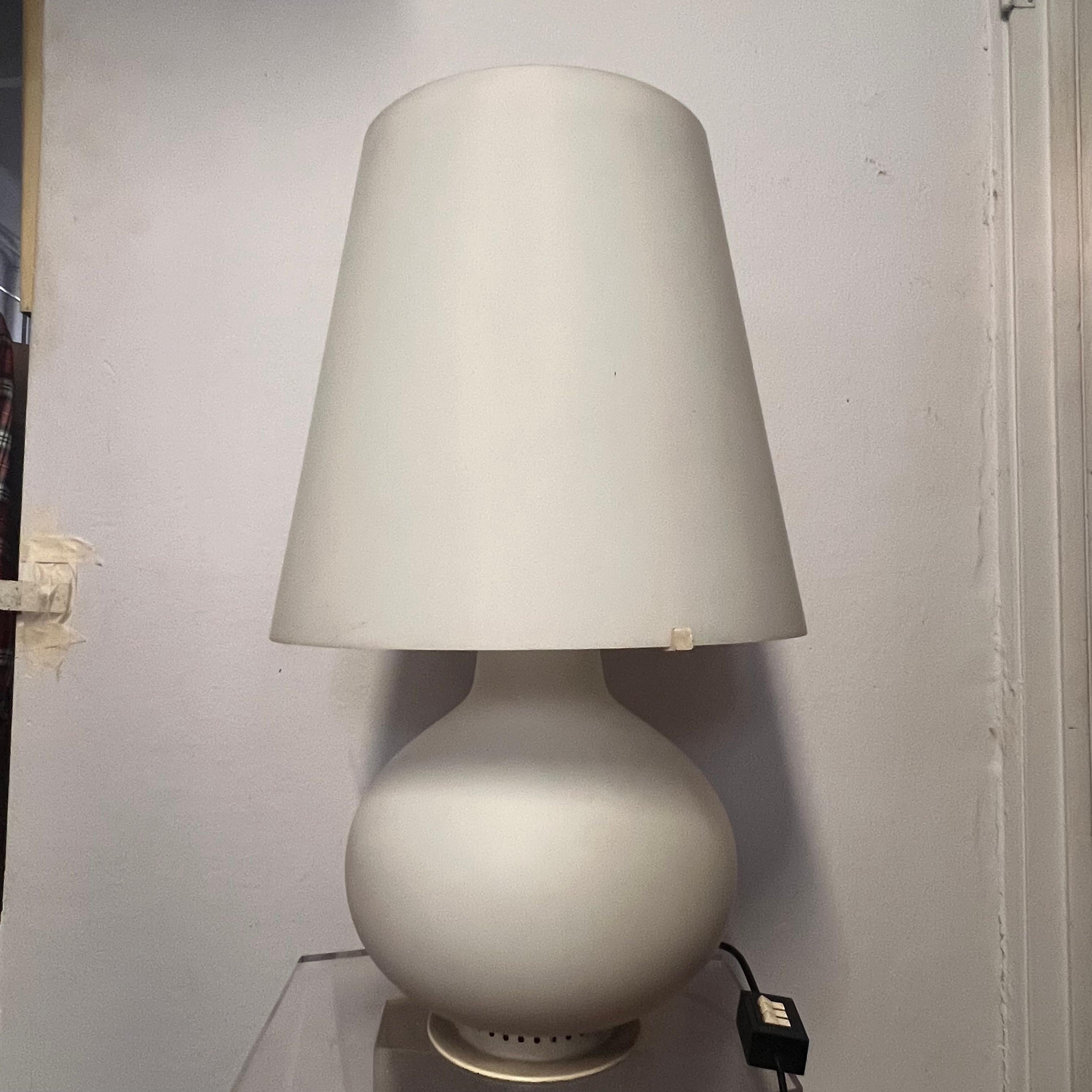 The lamp is Max Ingrand's Model 1853 for Fontana Arte in its largest version.
The lampshade is a truncated cone shape made of white satin-blown glass, which diffuses light evenly and creates soft illumination.
The base has a bottle shape, also made