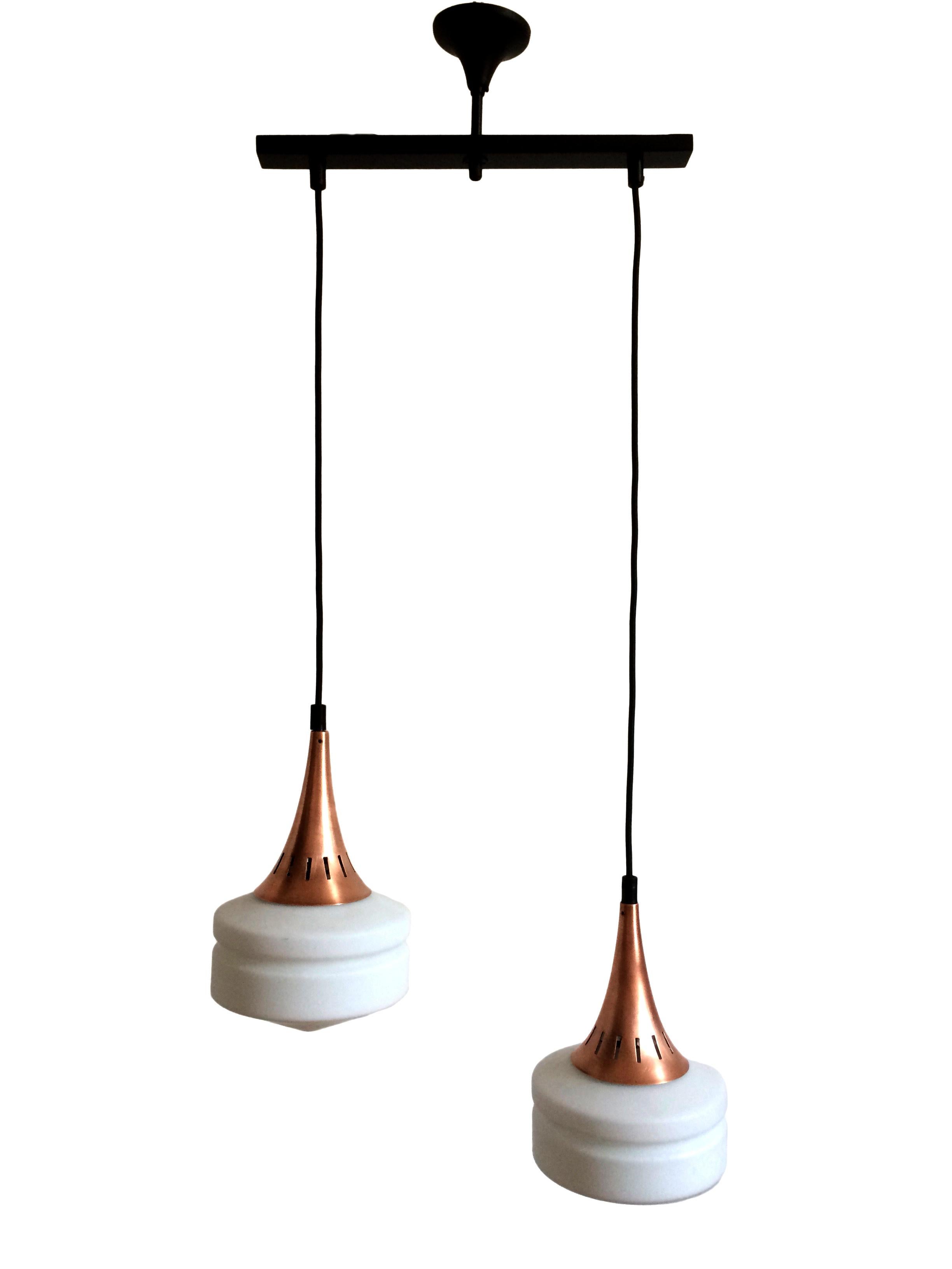 Ceiling lamp attributed to Stilnovo. Double milk-white opal glass diffuser. Copper, brass and black iron frame.

Italian pendant lamp, attributed to Stilnovo . Copper, brass and black iron structure. Two white opal glass lamp shades.  

Dim.  h110 X