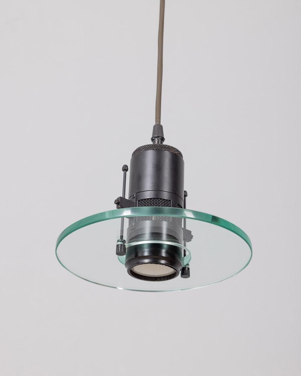 Minimalist hanging lamp, black metal and clear glass, Italian design, 1980s.

CONDITION:
In good, working condition, may show signs of wear given by time.

SIZING: 
Height 86 cm; Diameter 21 cm

MATERIALS: 
Metal and Glass

YEAR MANUFACTURED: 
Anni