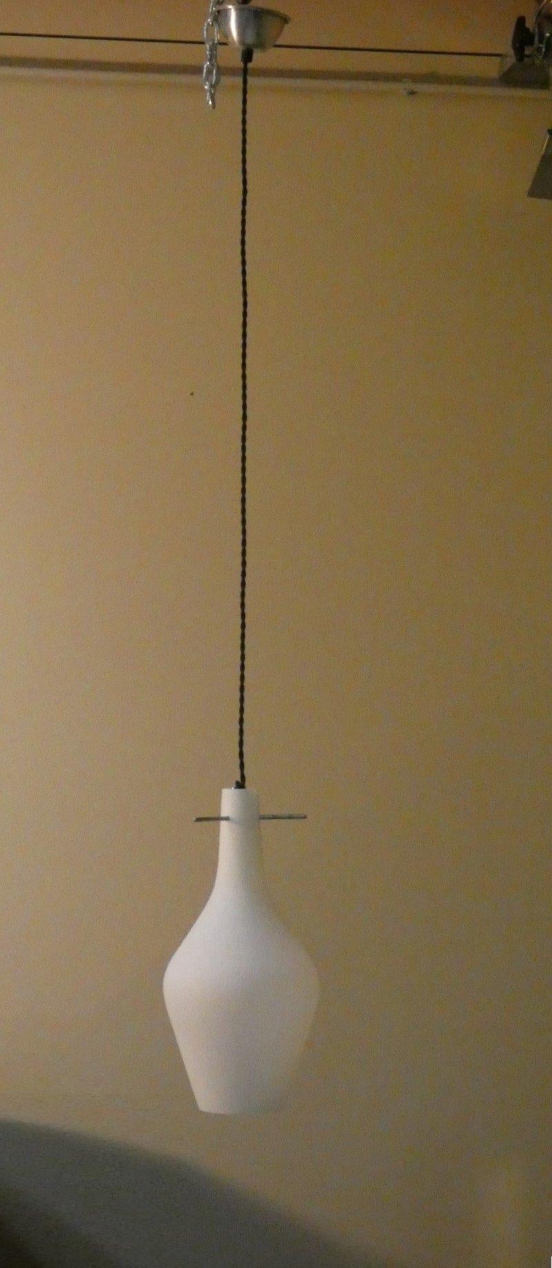 Rare and extremely elegant mid-century opaline glass and iron pendant lamp from the 1950s reminiscent of the Stilnovo and Arredoluce lamps of the same period.

Height of lamp is adjustable.

Maximum height: 120 cm
Diameter: 18 cm