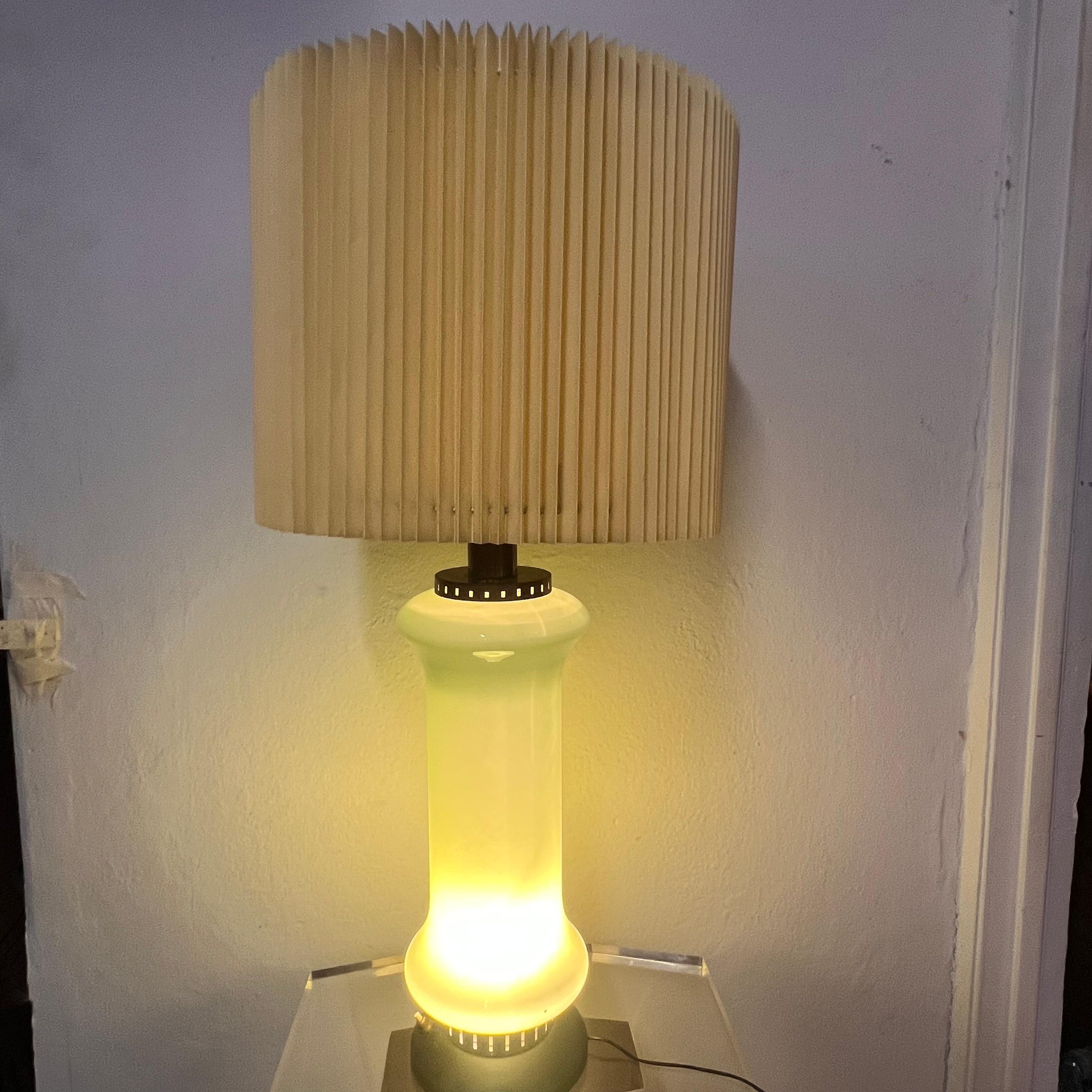 La lampada degli anni '50 prodotta da Stilnovo presenta un design che incarna perfettamente lo stile e l'innovazione del periodo. Stilnovo, fondata a Milano nel 1946, è nota per la produzione di illuminazioni che combinano funzionalità e bellezza