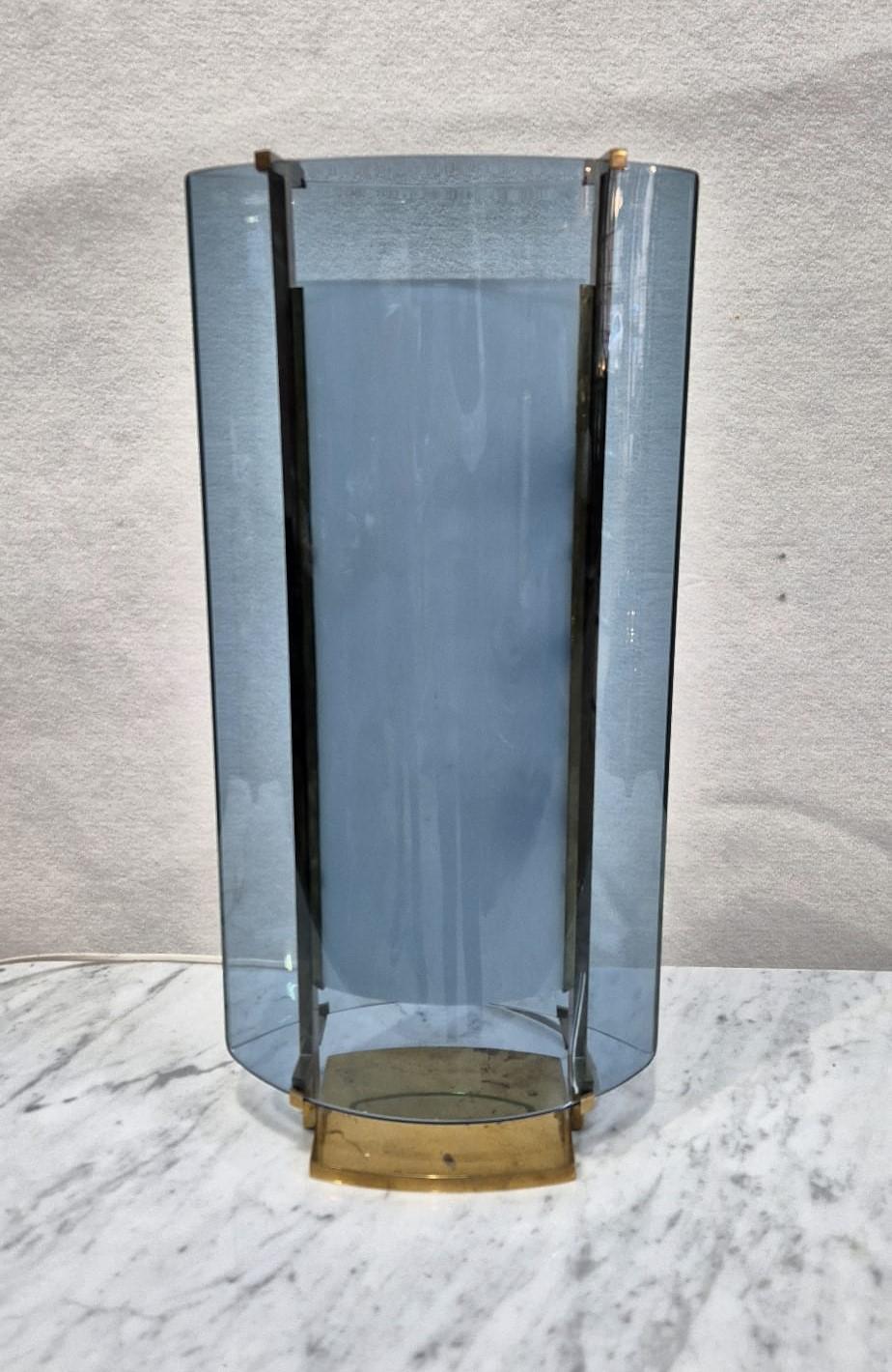 Lampada da tavolo Max Ingrand per Fontana Arte anniì60 circa. La Lampada está formada por dos vetri, uno azul y otro transparente, y por una estructura en otomano.
All'interno vi sono altri due vetri bianchi opalini.