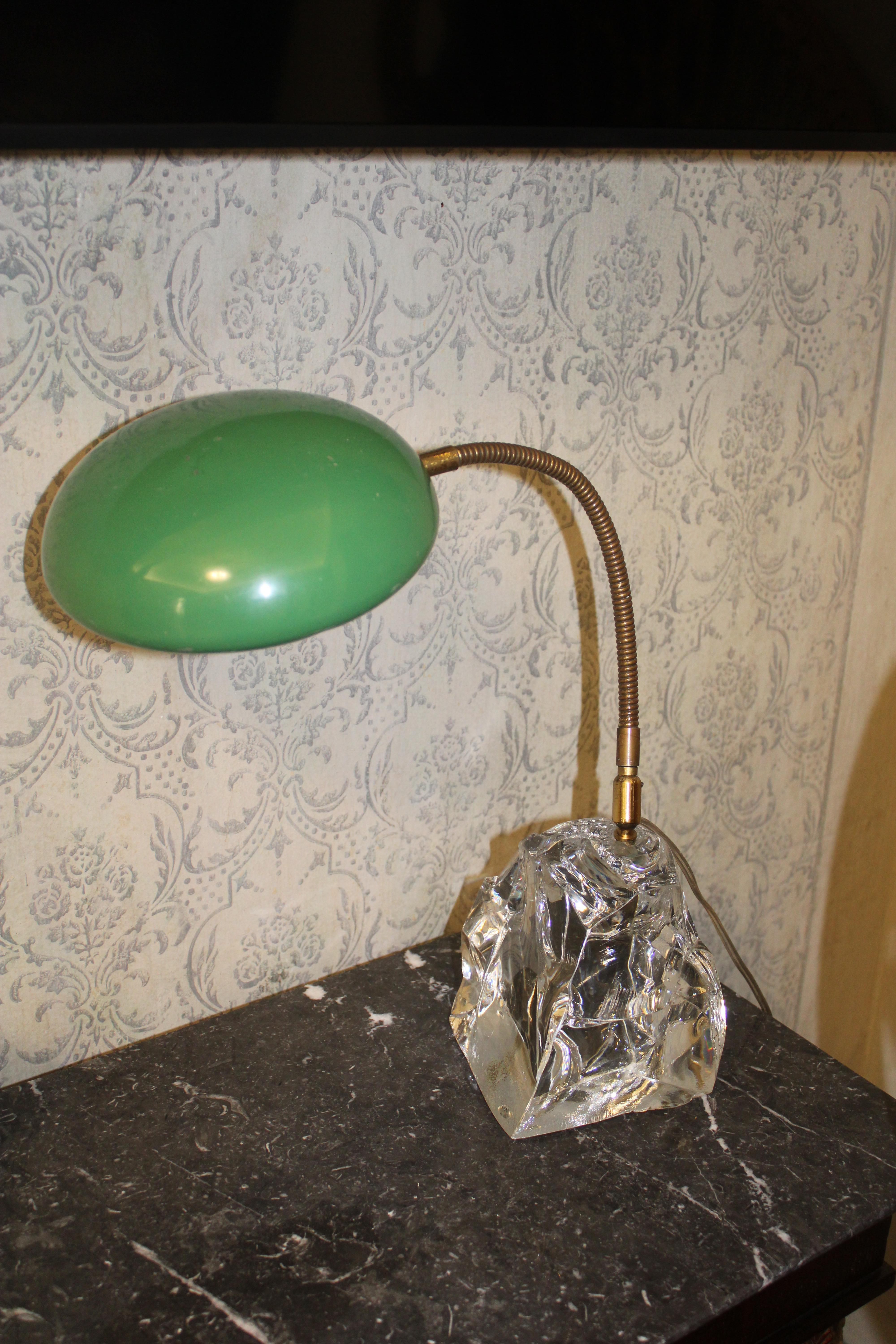 Peculiar table lamp , a crystal block with flexible brass arm and flattened round dome in green lacquered enamel.