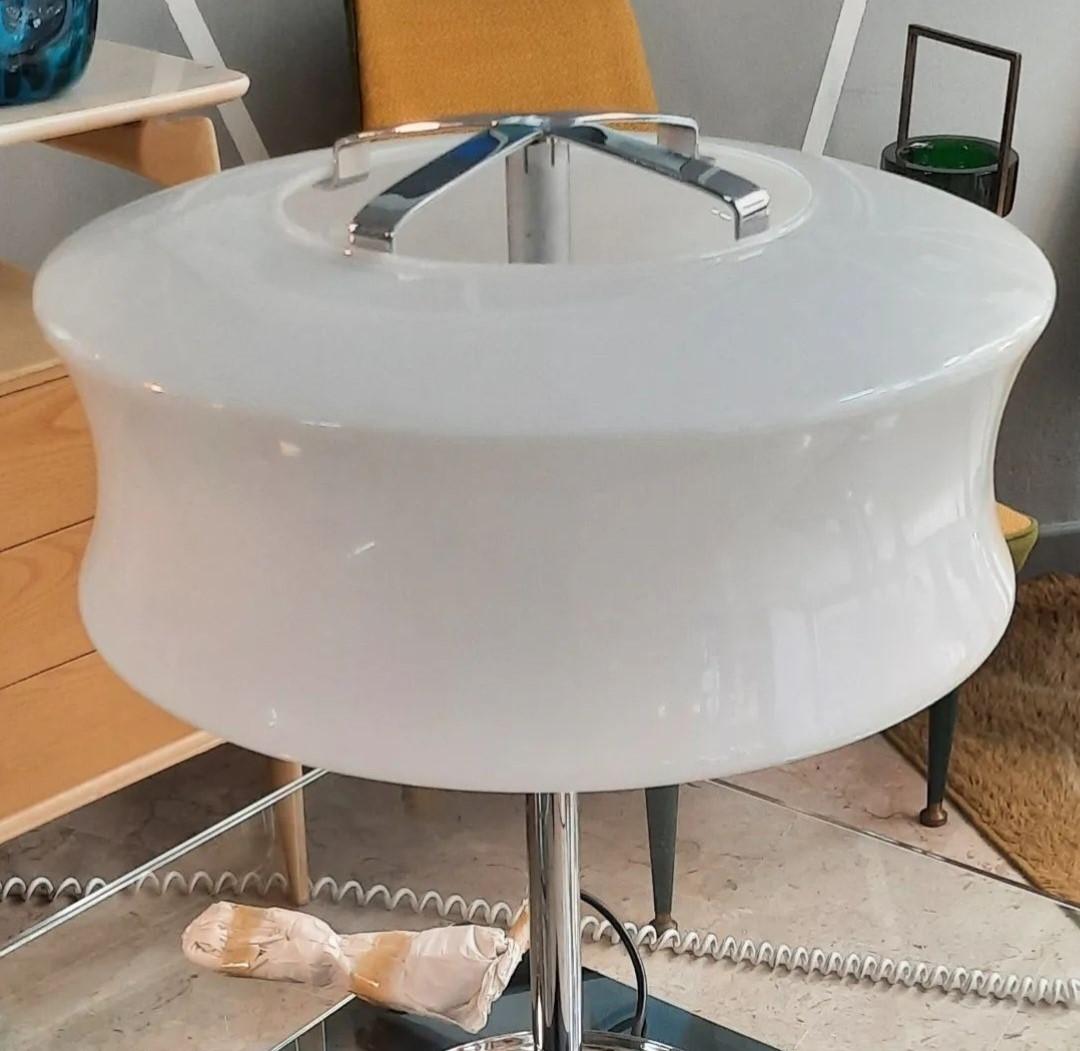 Gorgeous table lamp made around 1960 by Valenti, Milan, Italy.
The lamp has a stainless steel frame with three removable trays on the base, and a polished, opalescent glass shade. There is a cast iron disk under the base for balance. The lamp was