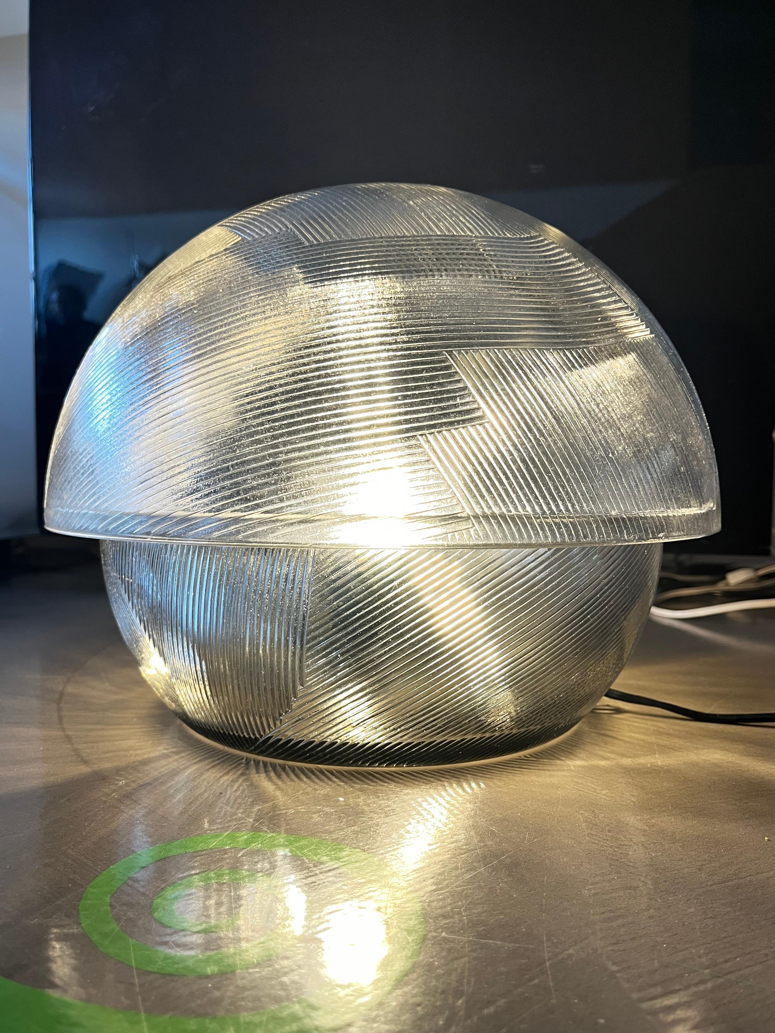 Lampe de table en cristal travaillé, modèle Kyoto,  conçu par Sergio Asti pour Arnolfo di Cambio. La lampe est datée de 1970 environ.

Le cristal travaillé rend l'effet de cette lampe magique. La lampe a un poids important. 