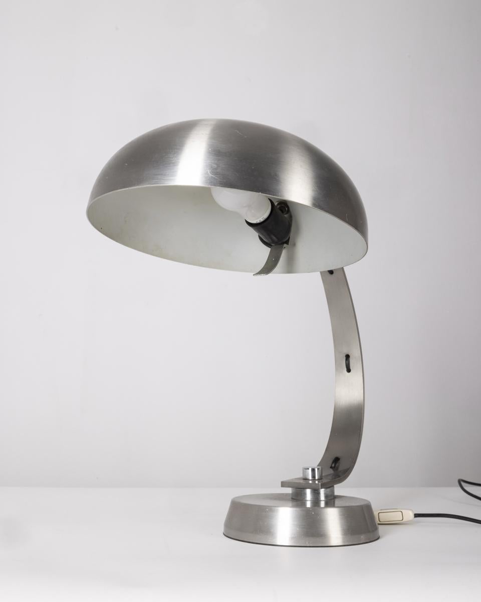 Ministerial table lamp totally made of chrome metal, adjustable shade, Italian design, 1970s.

CONDITION: In good, working condition, may show slight signs of wear given by time.

DIMENSIONS: Height 46 cm; Width 30 cm; Length 50 cm

MATERIALS: