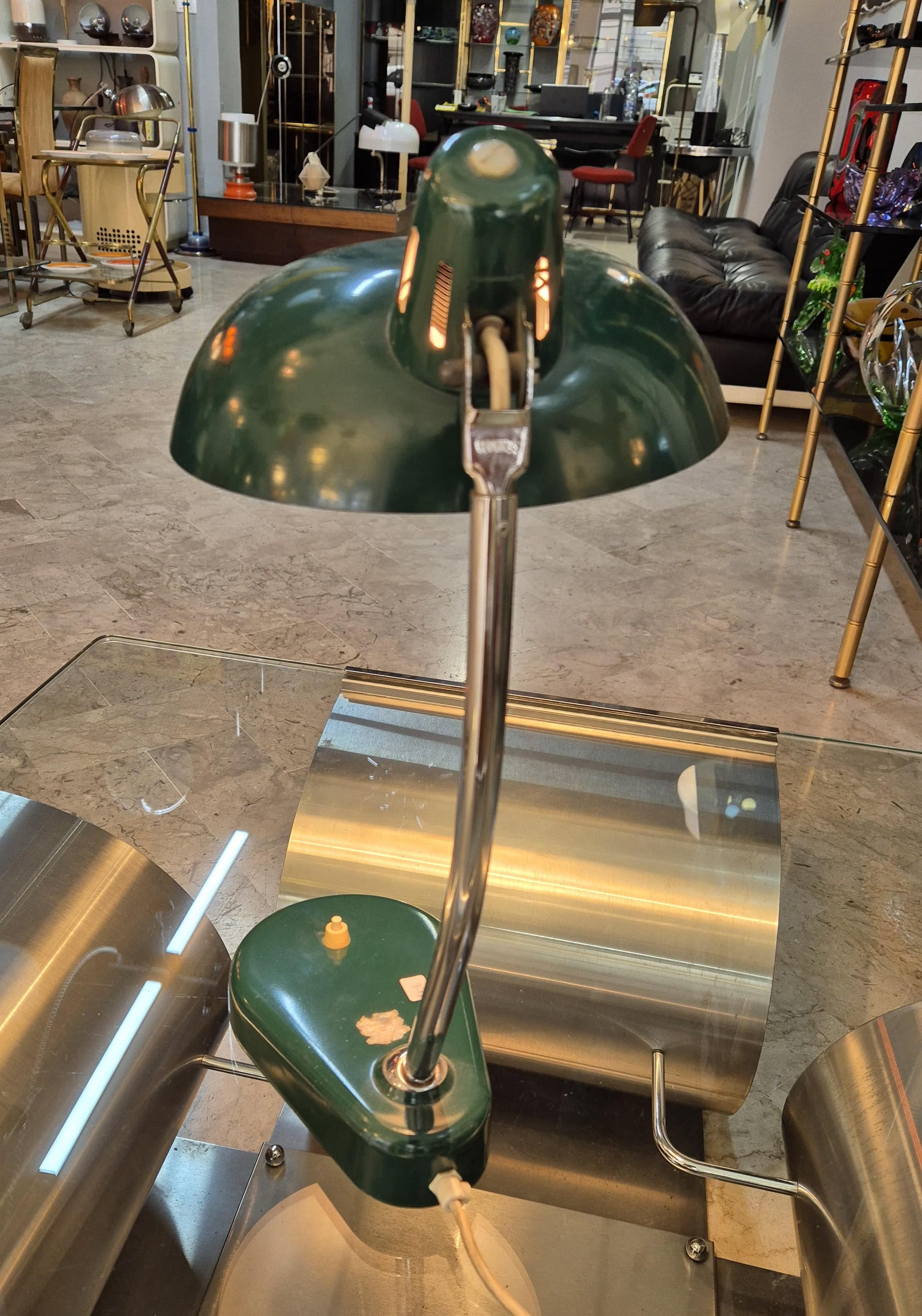 Green ministerial table/desk lamp circa 1960s.
The lamp is in good condition, with some signs of wear given by time.  The power cord has been changed.