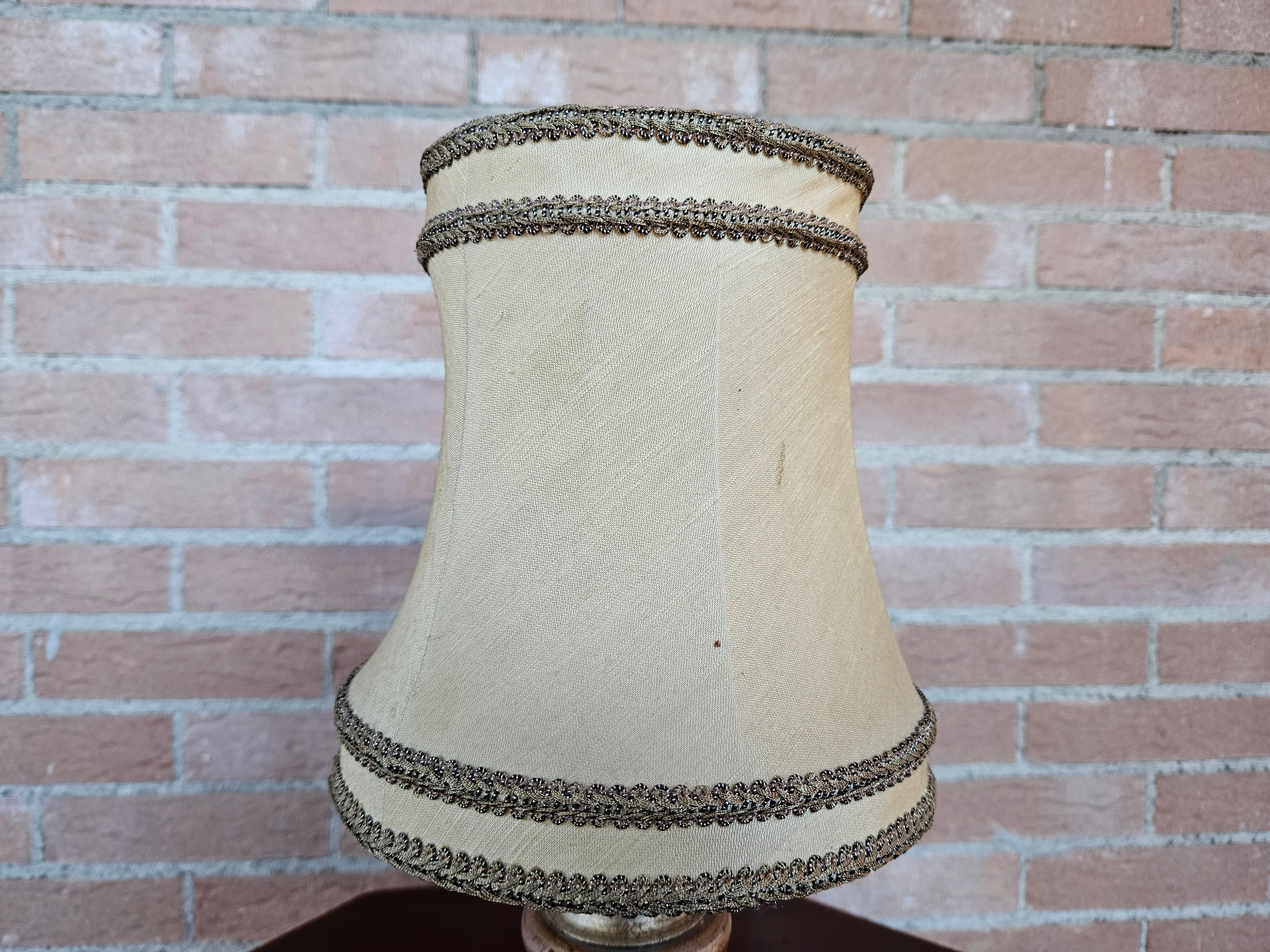 Bedside lamp (abat jour) or small wooden table lamp with cloth shade.

Bulb not included.