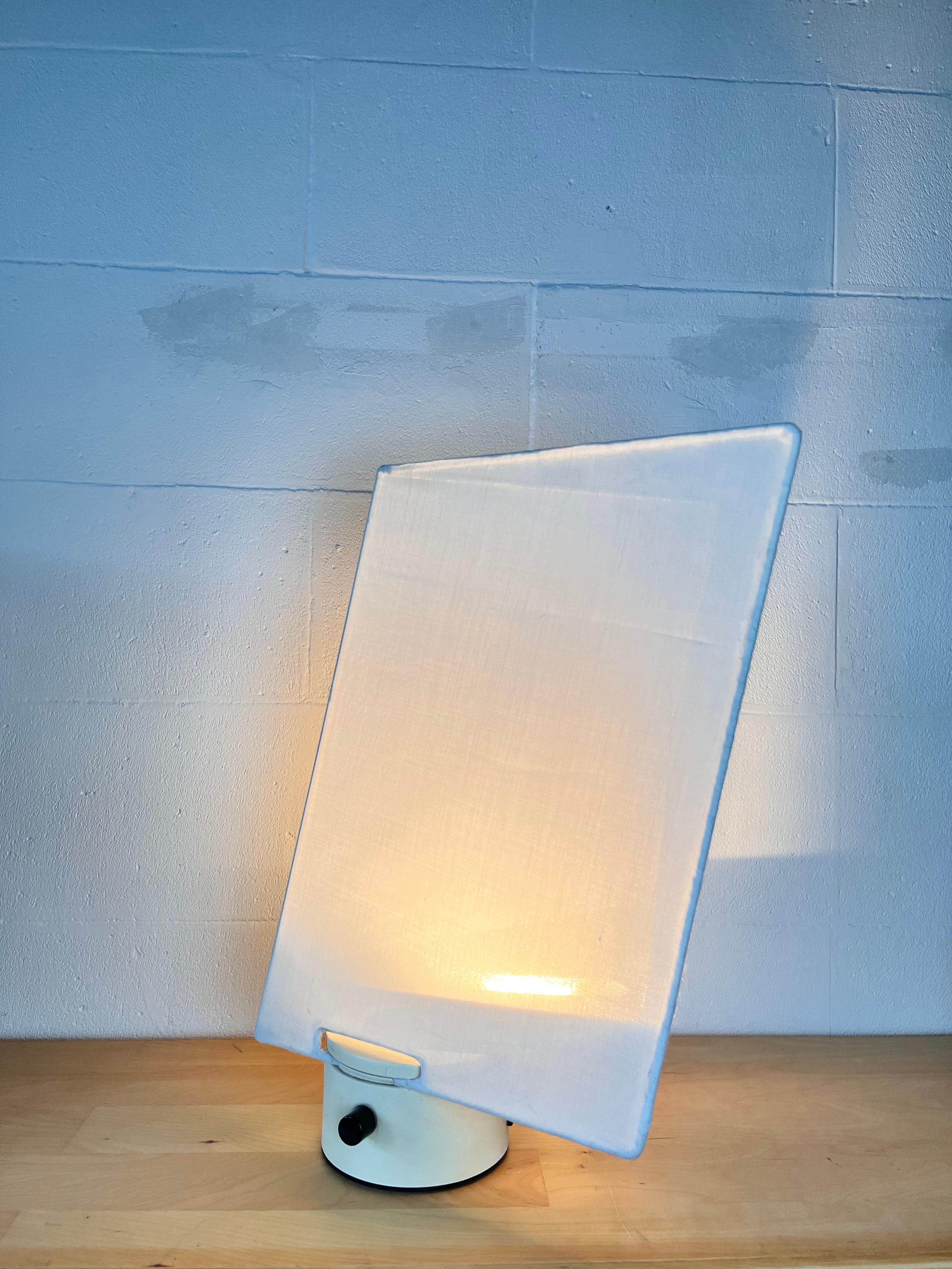Rare and scenic lamp by Carla Venosta for Luci designed and produced in 1970. 

The dimmable lamp consists of a creamy white lacquered embossed metal base and thin fabric shade. 

Overall good condition for a rare lamp hard to find in this coloring. 