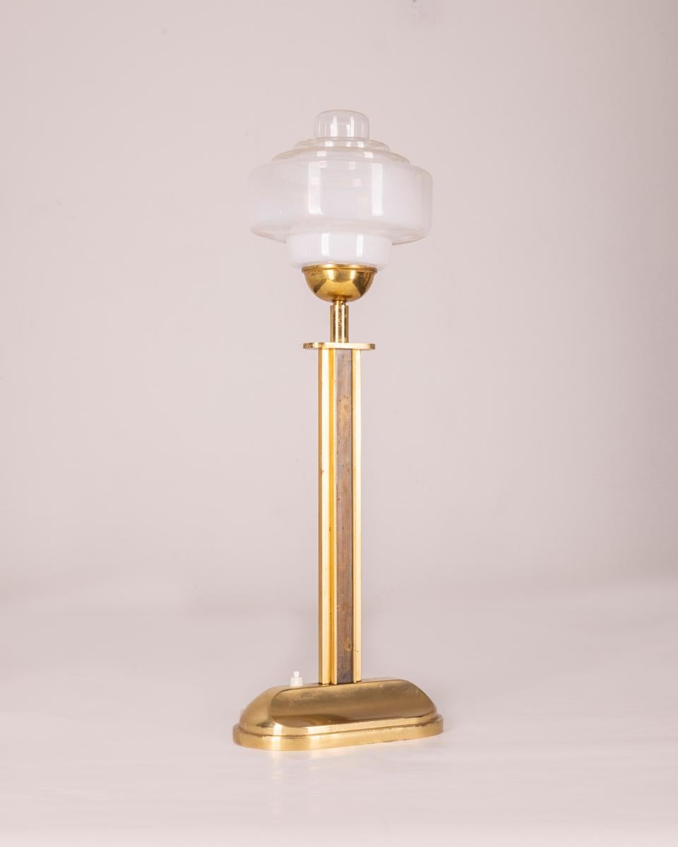 Gilt brass table lamp and glass shade, 1960s.

CONDITION: In good condition, working, shows signs of wear given by time.

DIMENSIONS: Height 65 cm; Width 23 cm; Length 19 cm

MATERIAL: Brass and Glass

YEAR OF PRODUCTION: Anni 60