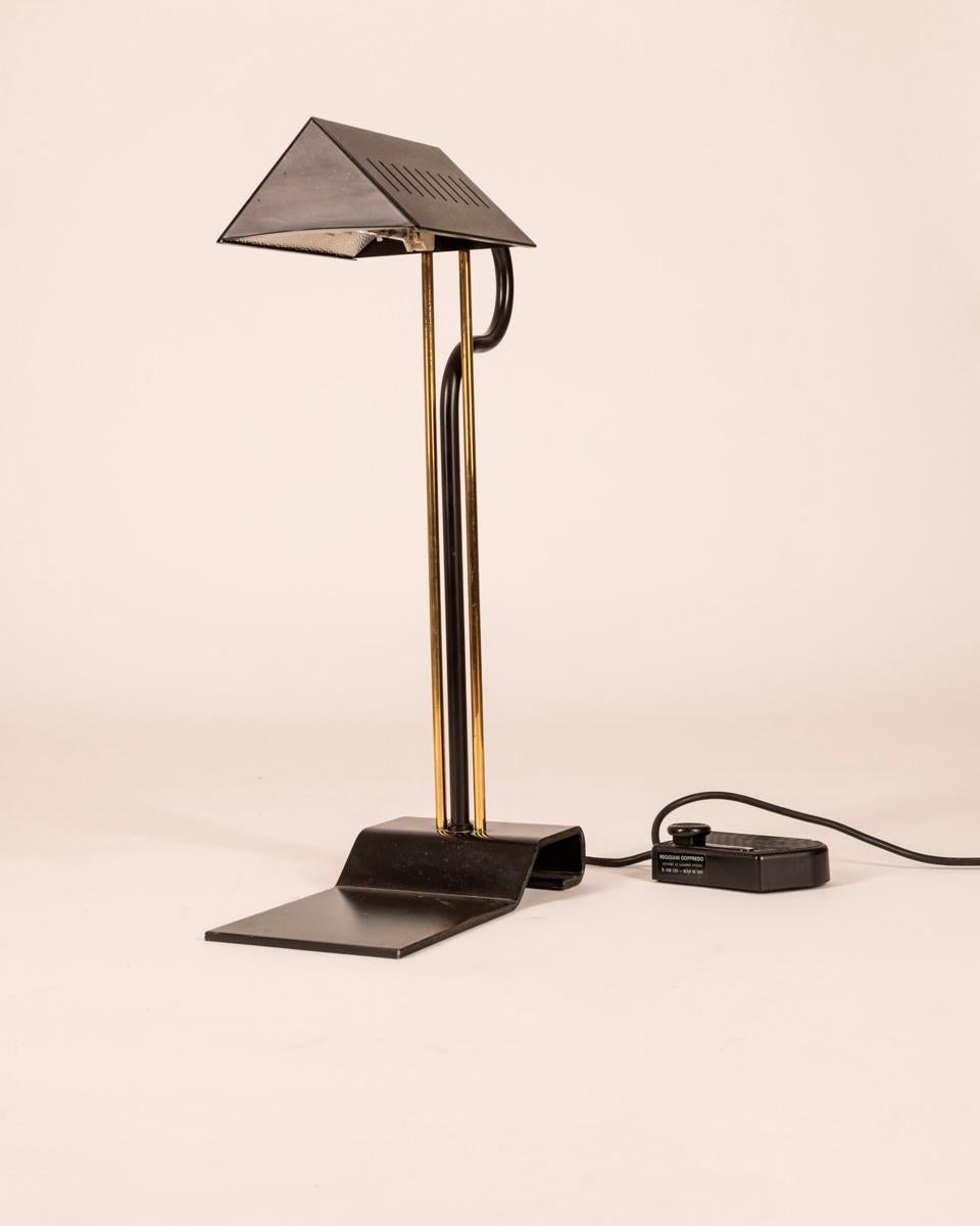 Black metal and gilt brass table lamp with dimmer for adjusting light intensity, design Goffredo Reggiani, 1970s.

CONDITION: In good condition, shows signs of wear given by time.

DIMENSIONS: Height 51 cm; width 14 cm; length 25 cm;

MATERIAL:
