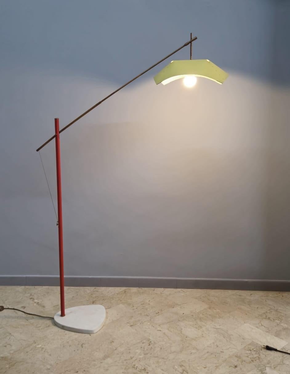 Floor lamp designer Angelo Lelli for Arredoluce, Monza.
Metal and lacquered metal frame with yellow lacquered aluminum diffuser and marble base. Fully functional, excellent condition.
Presents the mark in the switch.