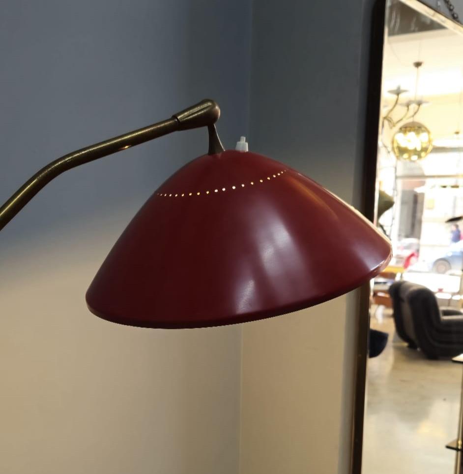 Rare Stilnovo floor lamp, 1950s.
Designed and manufactured in Italy. Patinated brass frame, red enameled metal shade, marble base. Lampshade adjustable in all directions.
Fully functional electrical system.