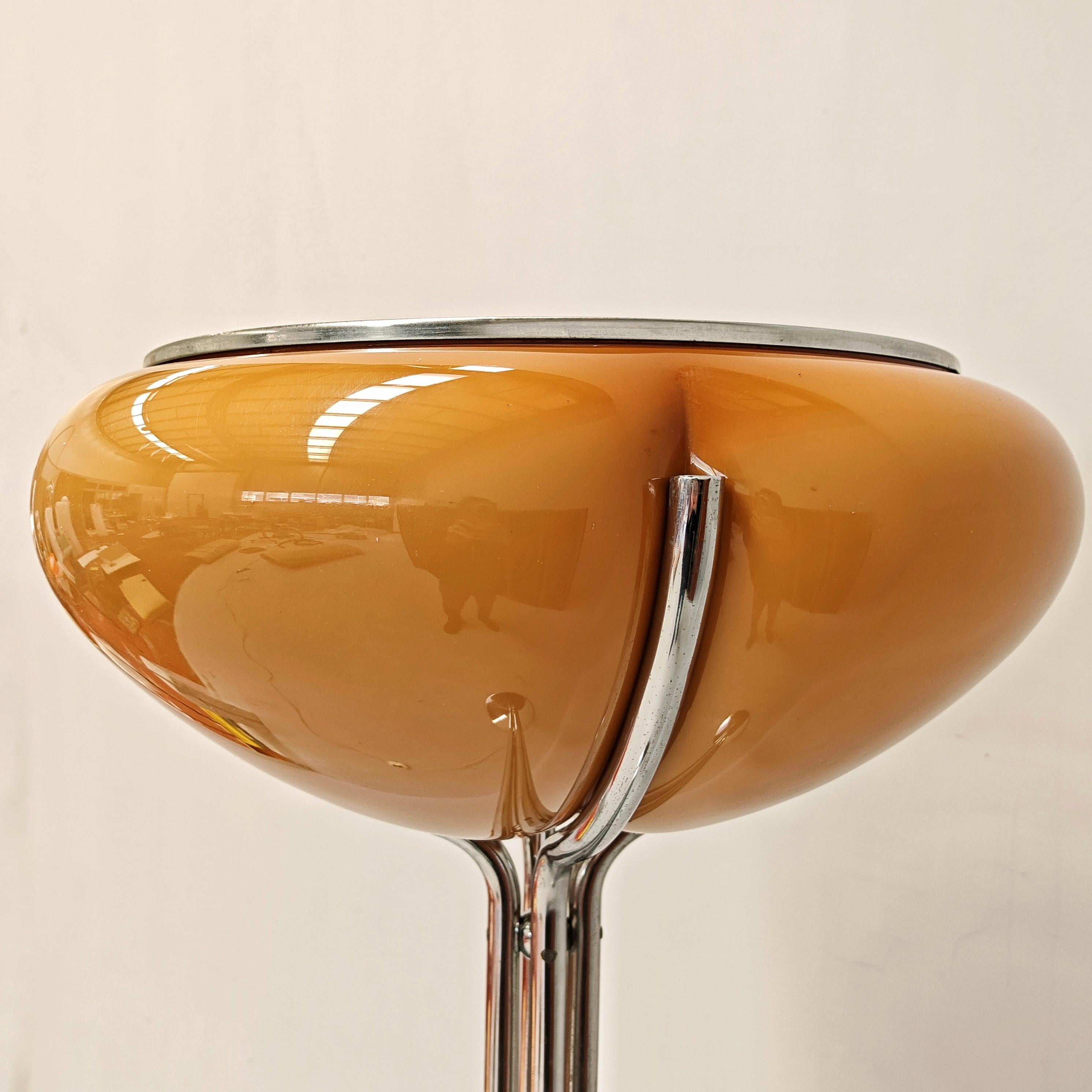 Stunningly ornamental Lamp designed by famous Italian Designer Gae Aulenti for the historic and iconic Italian manufacturer of lamps and acrylic plastic objects Harvey Guzzini.
This version has an amber cap that produces a warm, atmospheric light