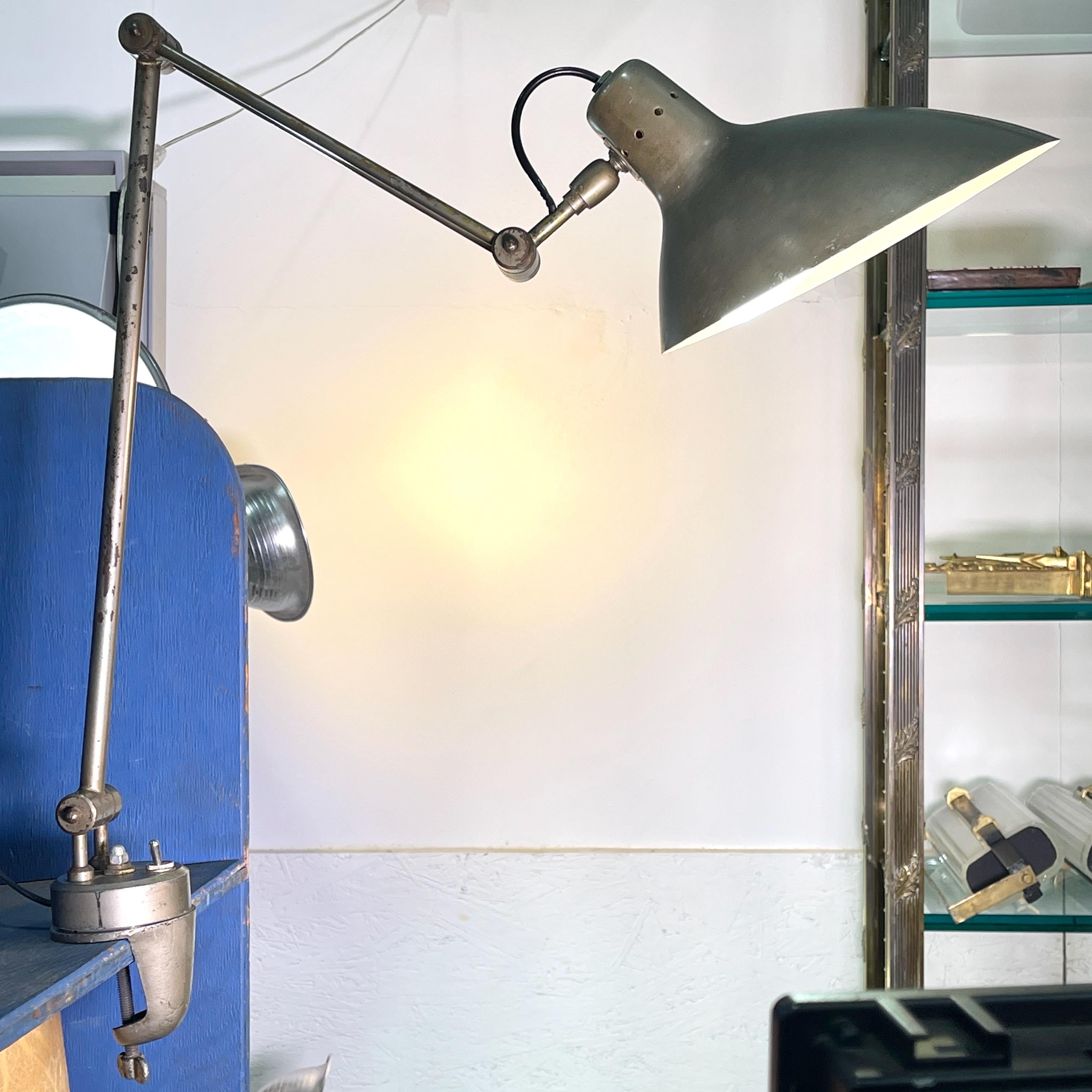 Very uncommon articulating and swiveling clamp mounted drafting table lamp produced by Lampada Ministero of Torino, Italy which was the dba of ditta Agostino Perazzone di Torino, a prolific producer of task and ministerial type lamps since the late
