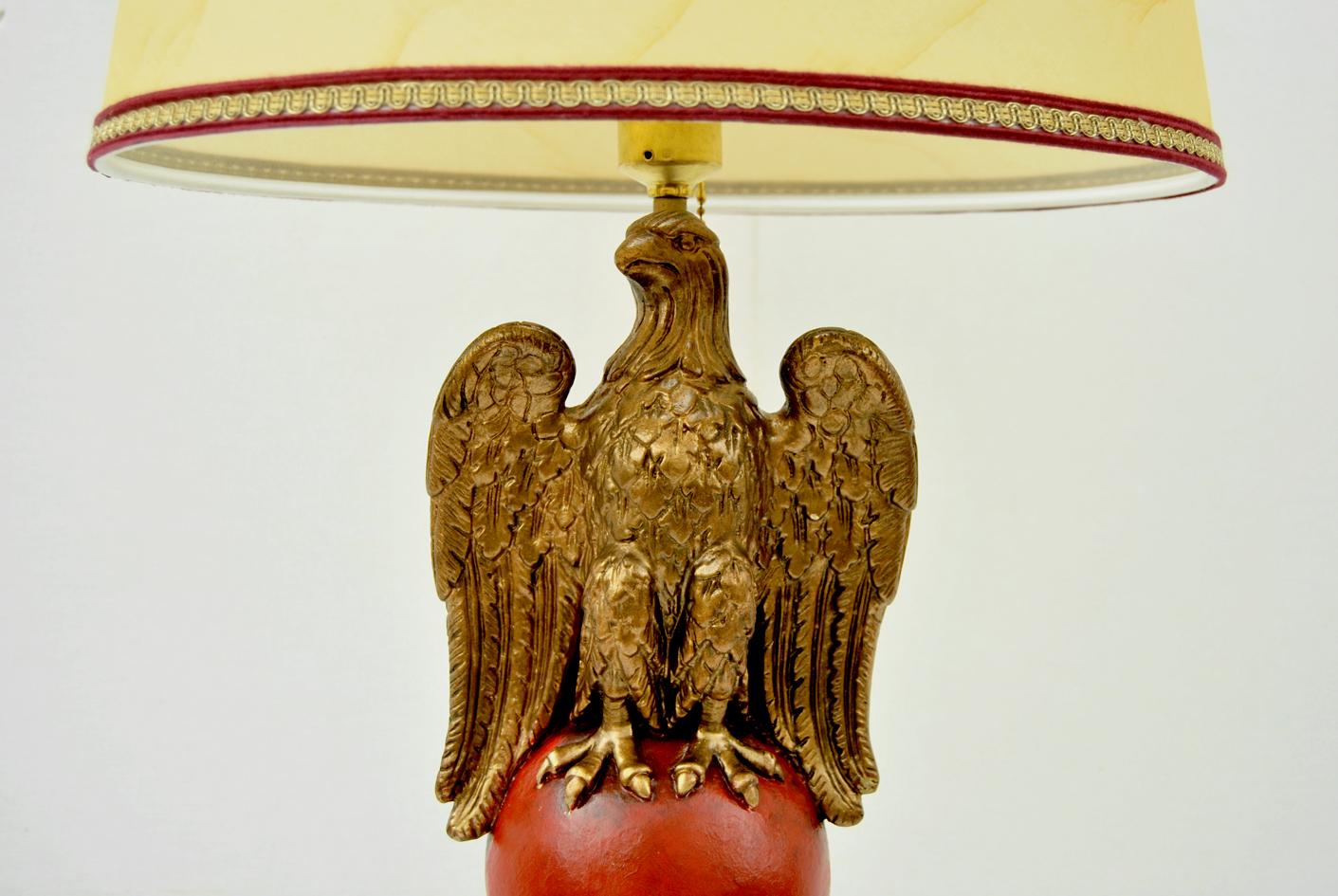 Beautiful German table lamp year 1940. This beautiful lamp comes from Germany and dates back to World War II.
The lacquered wooden column, is topped by the eagle made  in gilded marble powder; the whole rests on a brass base. 
Restored item, is in