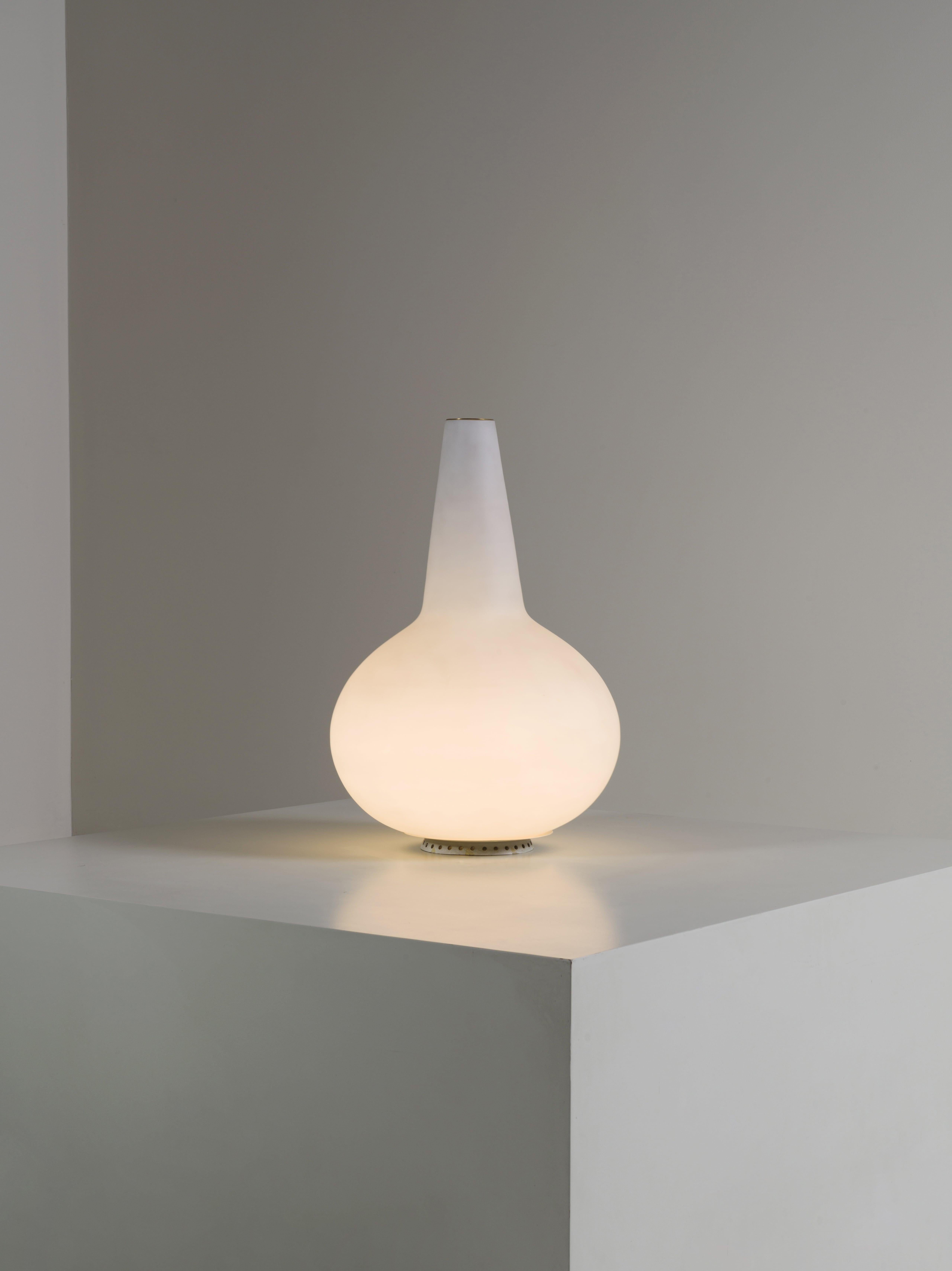 Lampada da Tavolo modello 1837/1 in vetro opalino a forma di vaso monofiore, disegnato da Max Ingrand per Fontana Arte Italia 1956.
Bellissimo vaso illuminato che presenta nella parte superiore un piccolo cilindro in ottone che consente di inserire