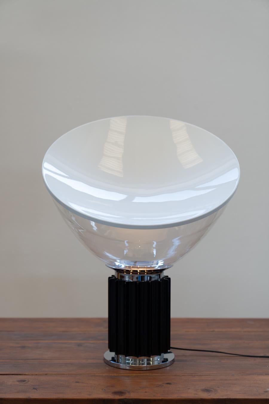 Taccia Vintage Lamp by Achille and Pier Giacomo Castiglioni, for Taccia
TACCIA  is a lamp designed and created by the Castiglioni brothers in 1962 for the Italian brand FLOS. It consists of a circular base on the air of Greek columns and a diffuser