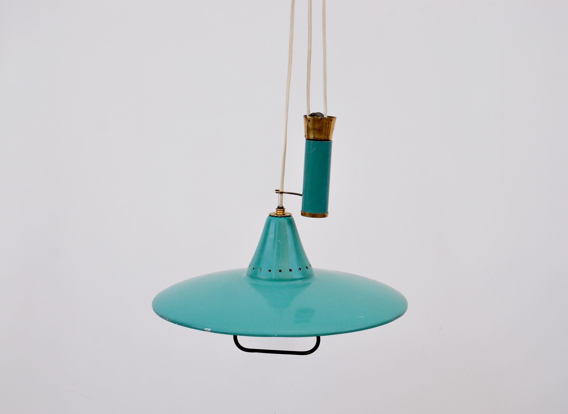 Brass, aluminum and metal pendant chandelier in the style of Stilnovo, 1950s, Made in Italy. 
Suspension chandelier with up-and-down mechanism with brass accessory under the enameled aluminum diffuser. It can be adjusted in height.
Condition is
