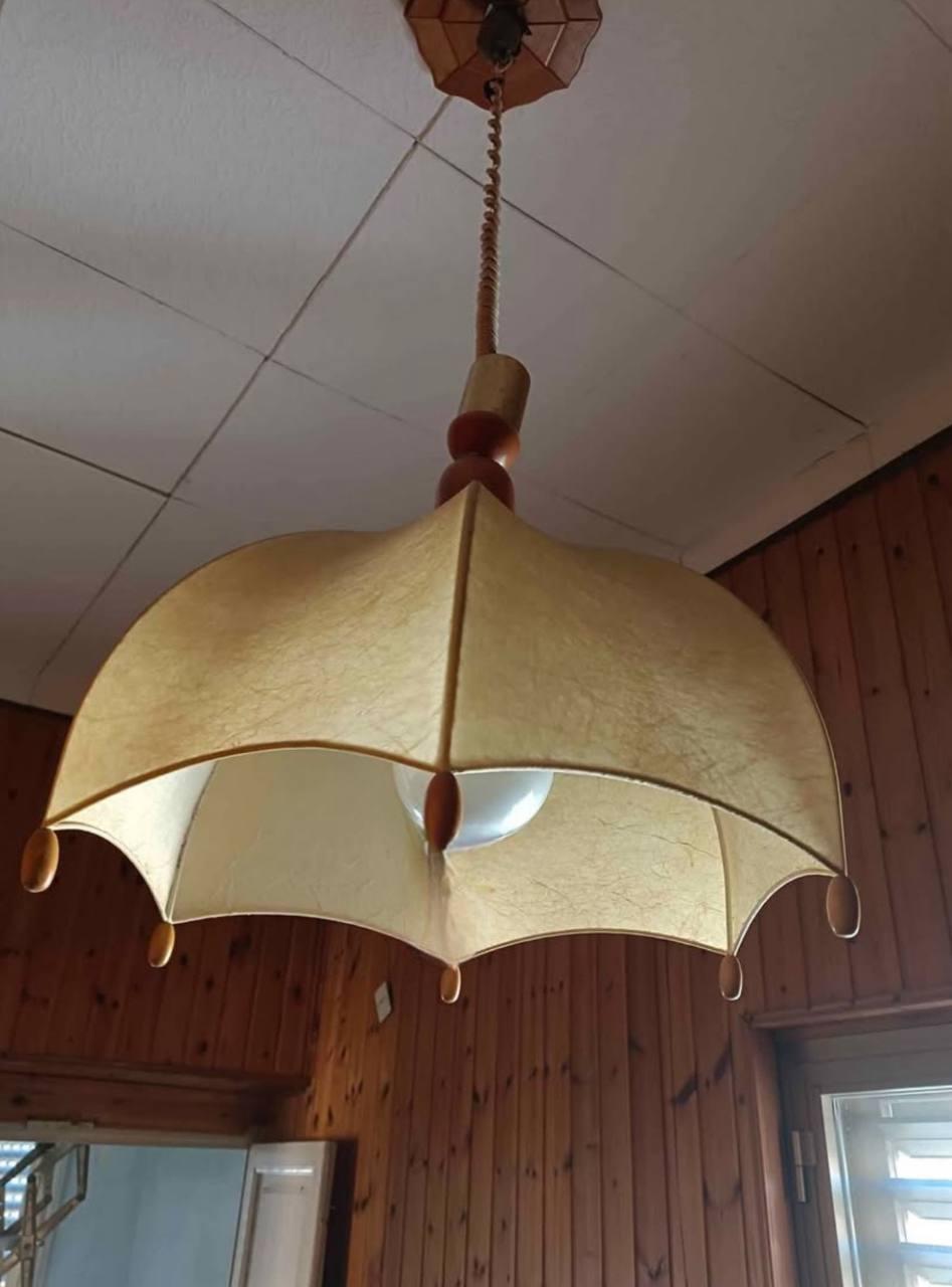 1970s Resin Cocoon Chandelier
The object presented is an emblematic example of mid-century Italian design, particularly the production of lamps made of resin, an innovative material for the time. The organic, enveloping shape, which is precisely