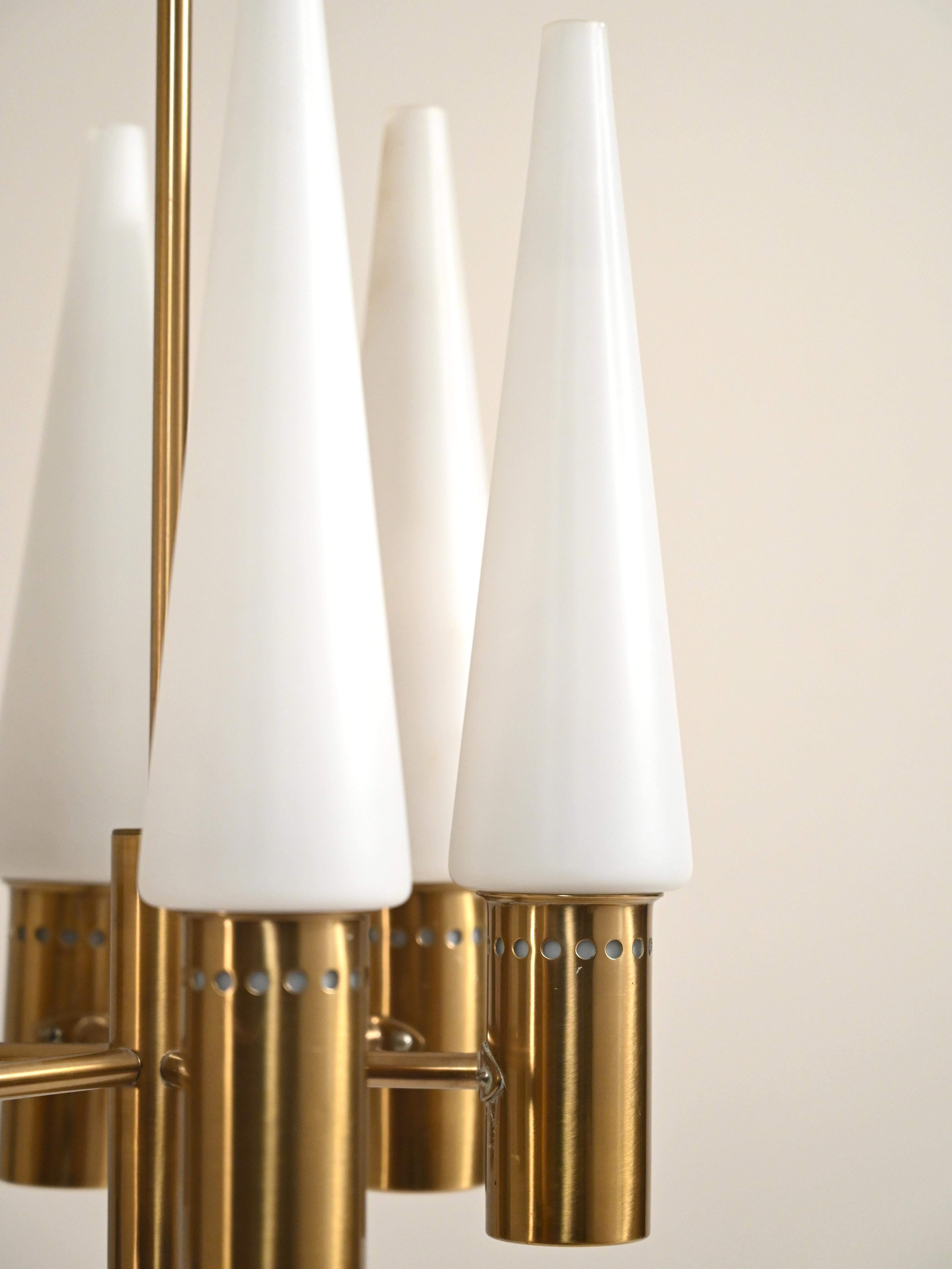 1950s chandelier by Hans-Agne Jakobsson for Markaryd, with six brass arms and opaline frosted glass shades.

Scandinavian chandelier designed by Hans-Agne Jakobsson in the 1950s for Markaryd. The brass structure unfolds into six symmetrical arms,