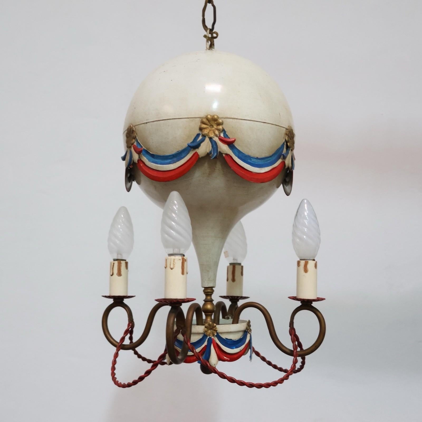 Raffinato e scenografico lampadario francese anni '50 realizzato in toleware dipinta, modellato con la caratteristica forma di una mongolfiera. Un pezzo di modernariato di grande fascino, unico per la sua lavorazione artigianale e per l'estetica