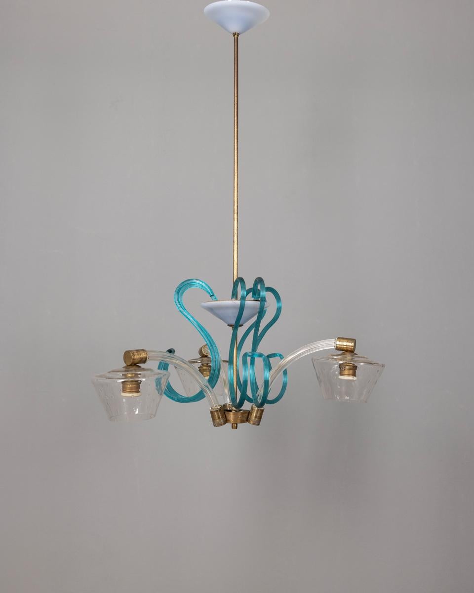 Three-light chandelier made of clear Murano glass and blue Murano glass decorations, with gilded brass inserts, Italian design, 1950s.

CONDITION:
In good, working condition, may show signs of wear given by time.

SIZING:
Height 95 cm; Diameter 58 cm
