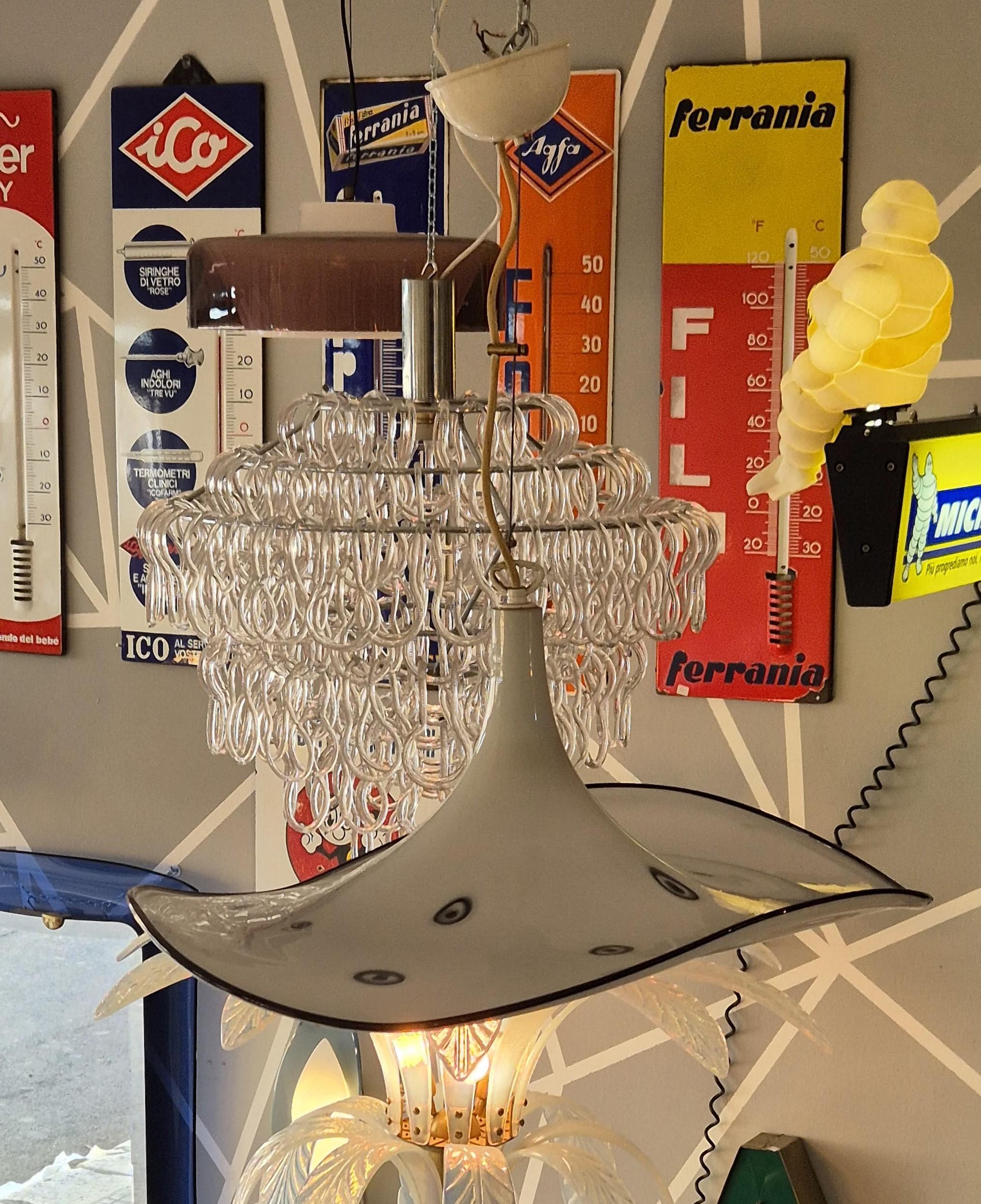 Chandelier shaped like a hat, made of white Murano glass with black details. Small designs in the shape of a circle. Approximate 1970s. The chandelier is in good condition, as can be seen from the photos themselves.