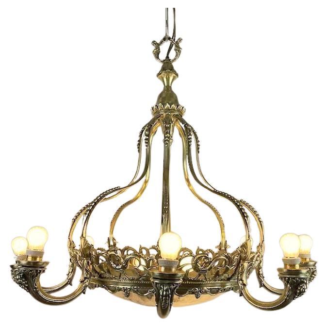 Italian Alabaster and Brass chandelier dating from around 1940 with ten lights, antique  art Deco Italian chandelier with circular frame, a beautiful brass casting, eight lights on curved arms and eight shaped dome-shaped uprights,  decorated  for
