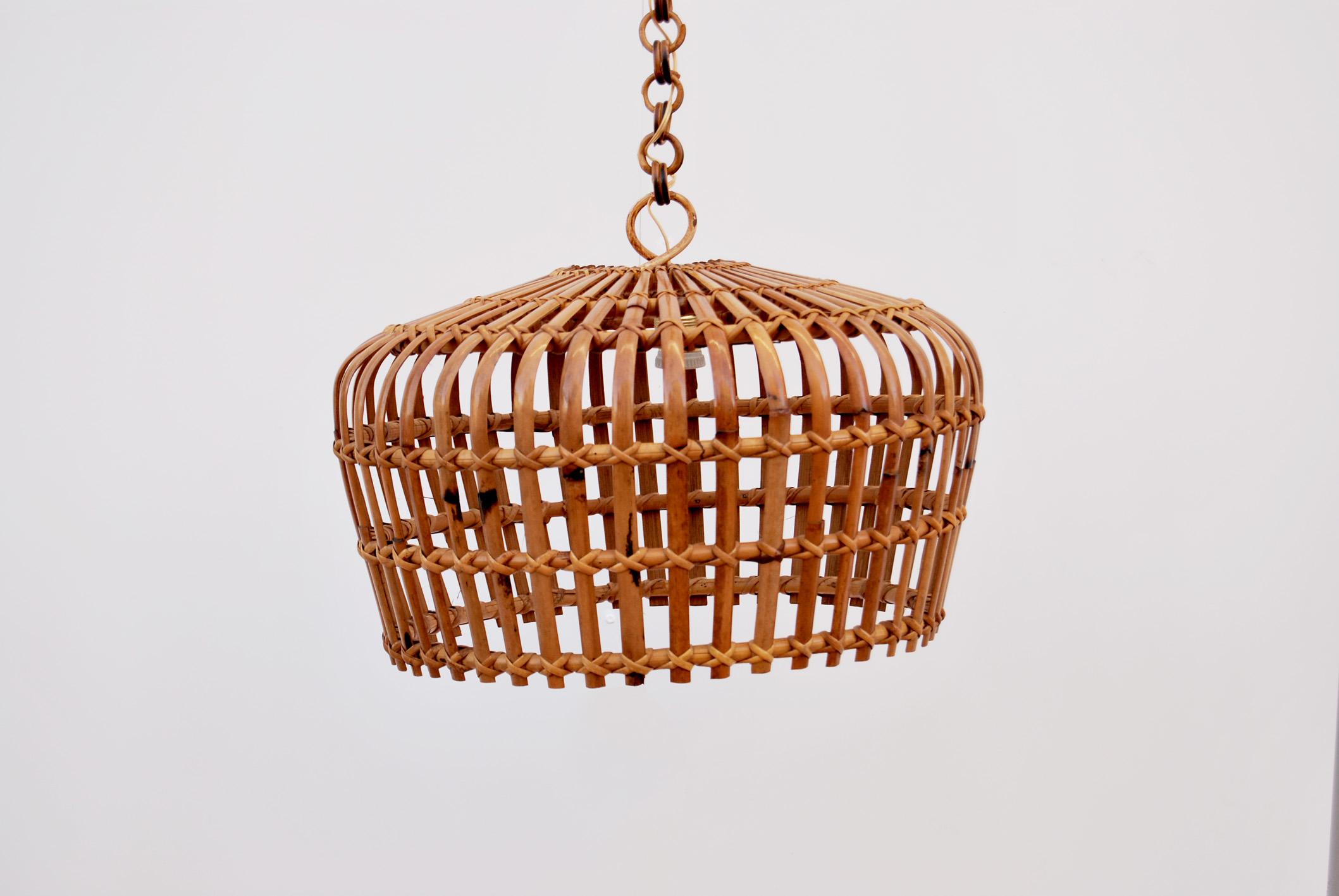Beautiful round bamboo and wicker hanging chandelier, 1960s, Made in Italy. 
The chandelier consists of an entirely handcrafted curved rattan shade, and the chain is composed of round rattan links, which can be adjusted in height. The chandelier has