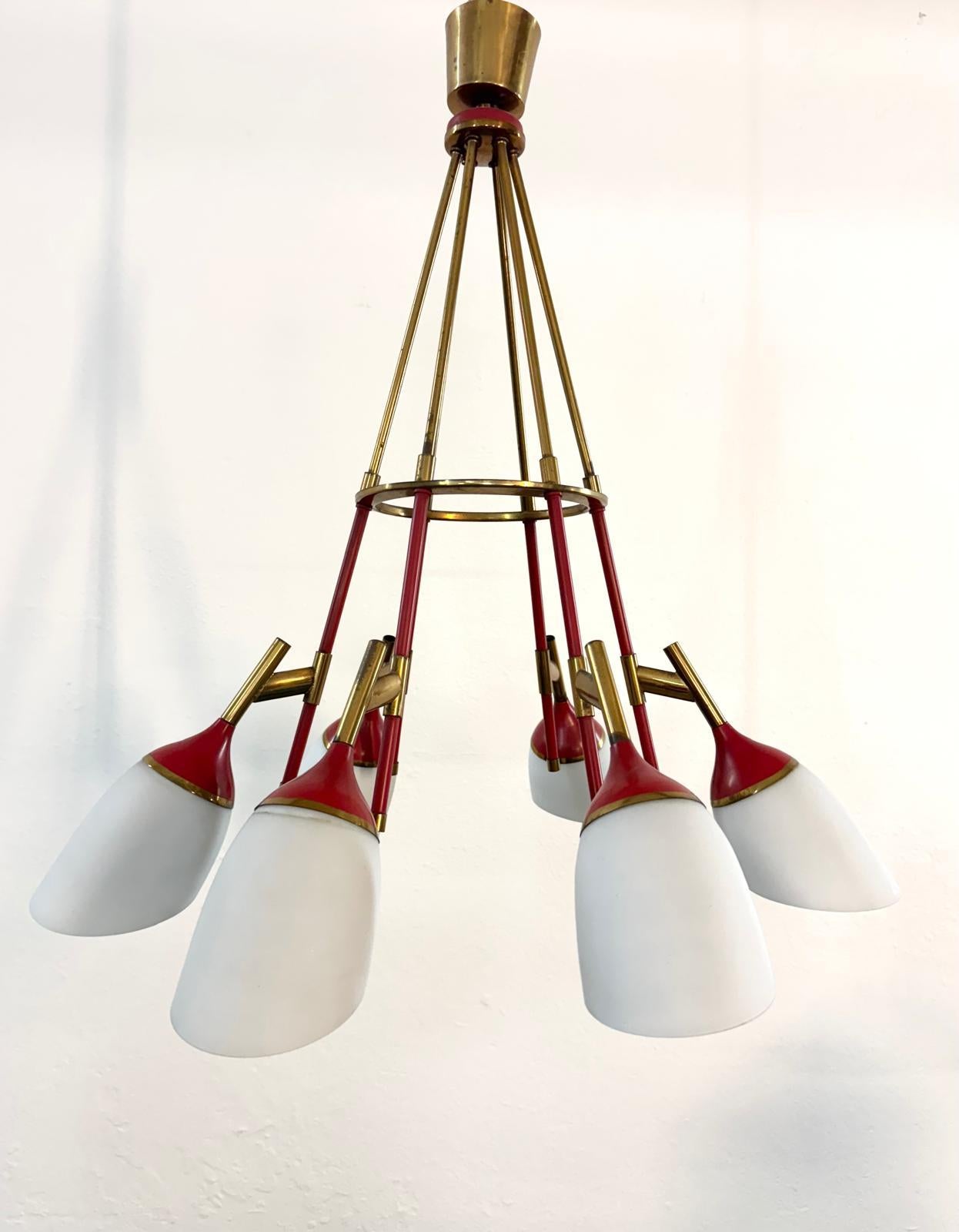 Chandelier in the Stilnovo-Sputnik style, circa 1950s-60s. Brass structure, with  six brass arms each ending in red lacquered brass cups and opaline glass shades. Good condition as pictured, light wear compatible with years.