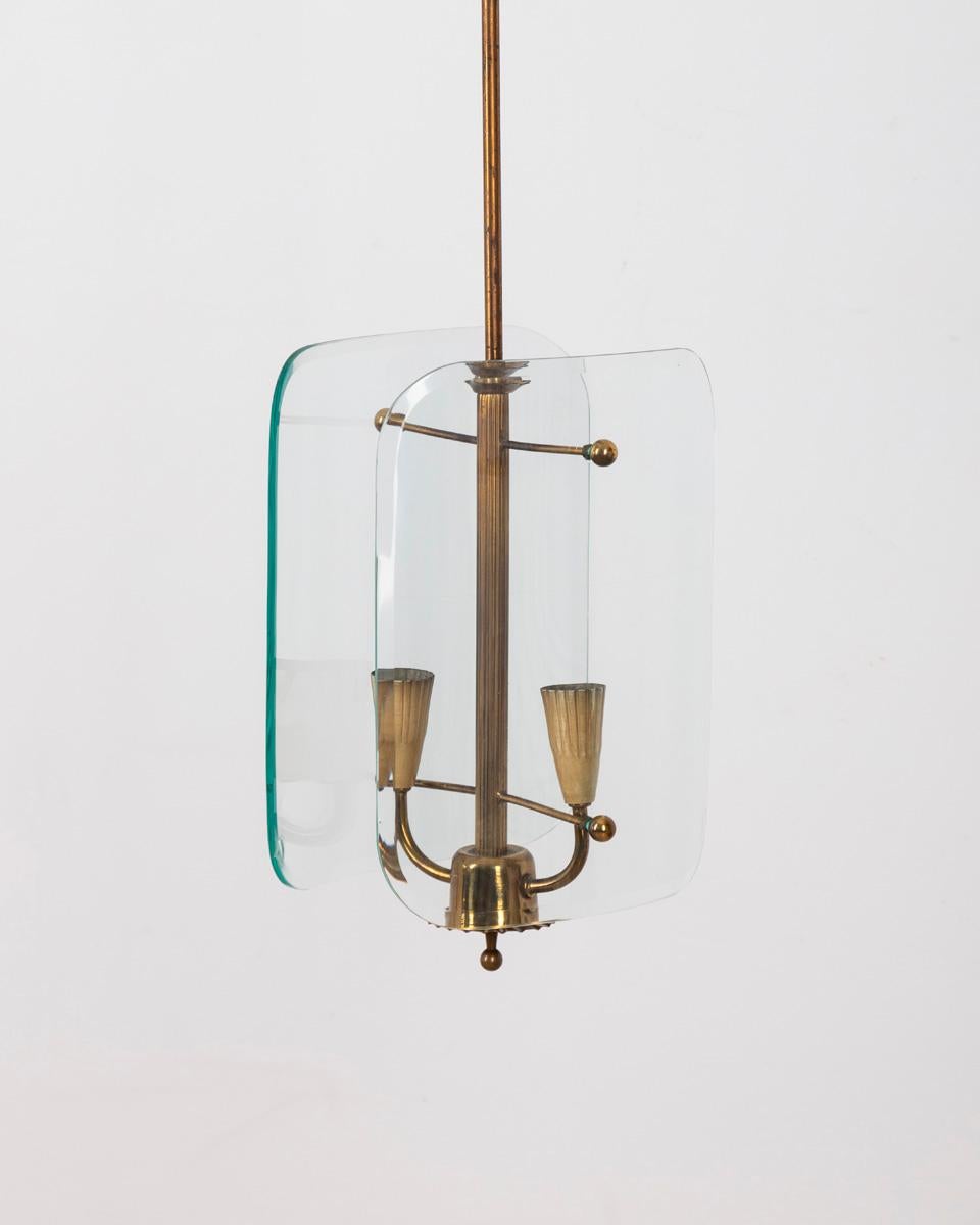 Chandelier with a gilt brass frame, two lights with clear beveled glass shades.
Design Pietro Chiesa for Fontana Arte, 1940s.

CONDITION: In good condition, working, has chipping on glass, visible in photo.

DIMENSIONS: Height 92 cm; Width 24 cm;