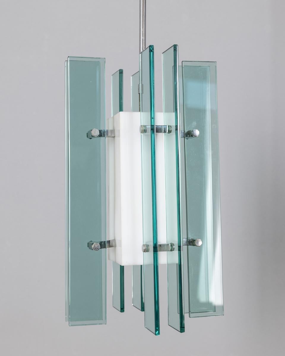 Chandelier with chrome metal frame, blue glass panels and white plastic central diffuser, Italian design, 1960s.

CONDITION:
In good, working condition, may show signs of wear given by time.

SIZING: 
Height 73 cm; Diameter 22 cm

MATERIALS: 
Metal