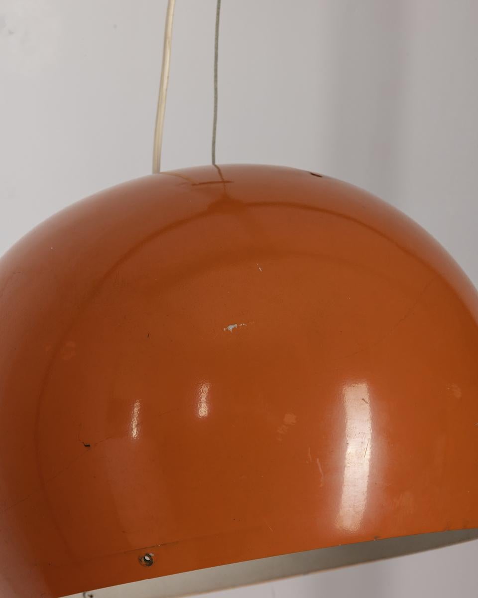 Orange metal pendant chandelier with adjustable shade, Italian design, 1970s.

CONDITION: In good, working condition, may show signs of wear given by time.

DIMENSIONS: Height 61 cm; Diameter 35 cm

MATERIALS: Metal

YEAR OF PRODUCTION: Anni 70