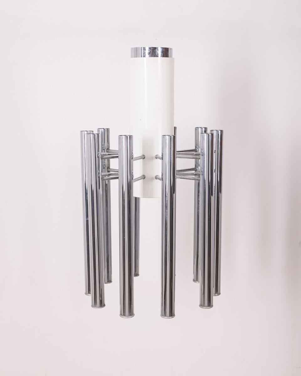 White and chrome metal chandelier with one central light and 10 side lights, Teodora model. Design Angelo Brotto for Esperia, 1980s.

CONDITION: In good, working condition, may show signs of wear given by time.

DIMENSIONS: Height 74 cm; Diameter 45