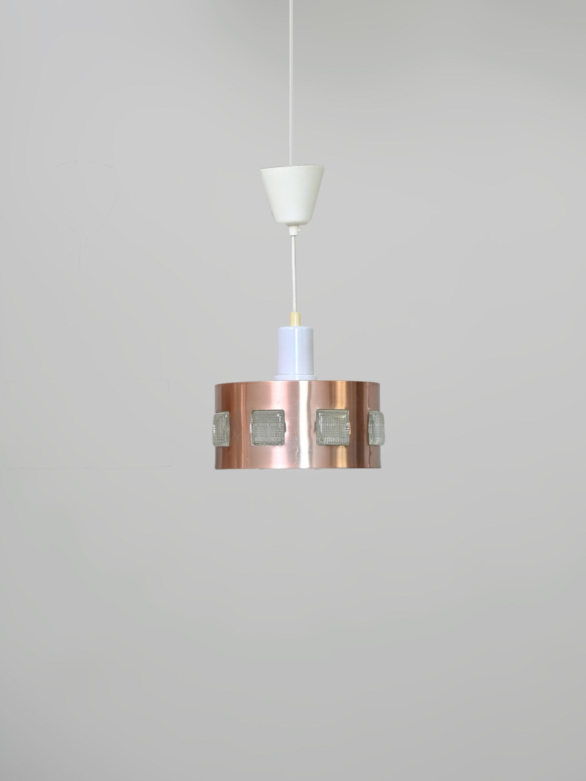 Pair of original Swedish vintage 1960s lamps.

Peculiar retro-style lamps with copper-colored metal lampshade.
The special feature of these furnishings is the crystal decorations embedded in the sheet metal part.

The light is directed downward, but