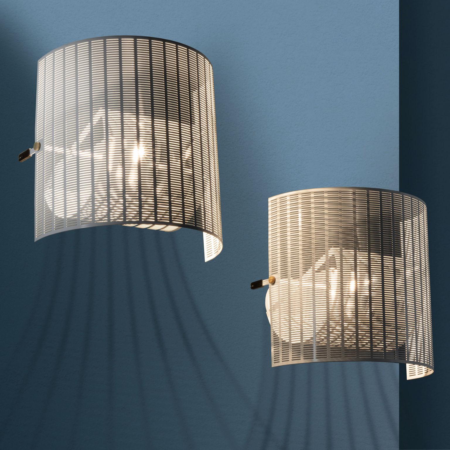 Pair of wall lamps model 'Shogun' designed by Mario Botta and  produced by Artemide since the 1980s. Made of white lacquered metal, they feature adjustable lampshades, useful for  vary the lighting effect.
