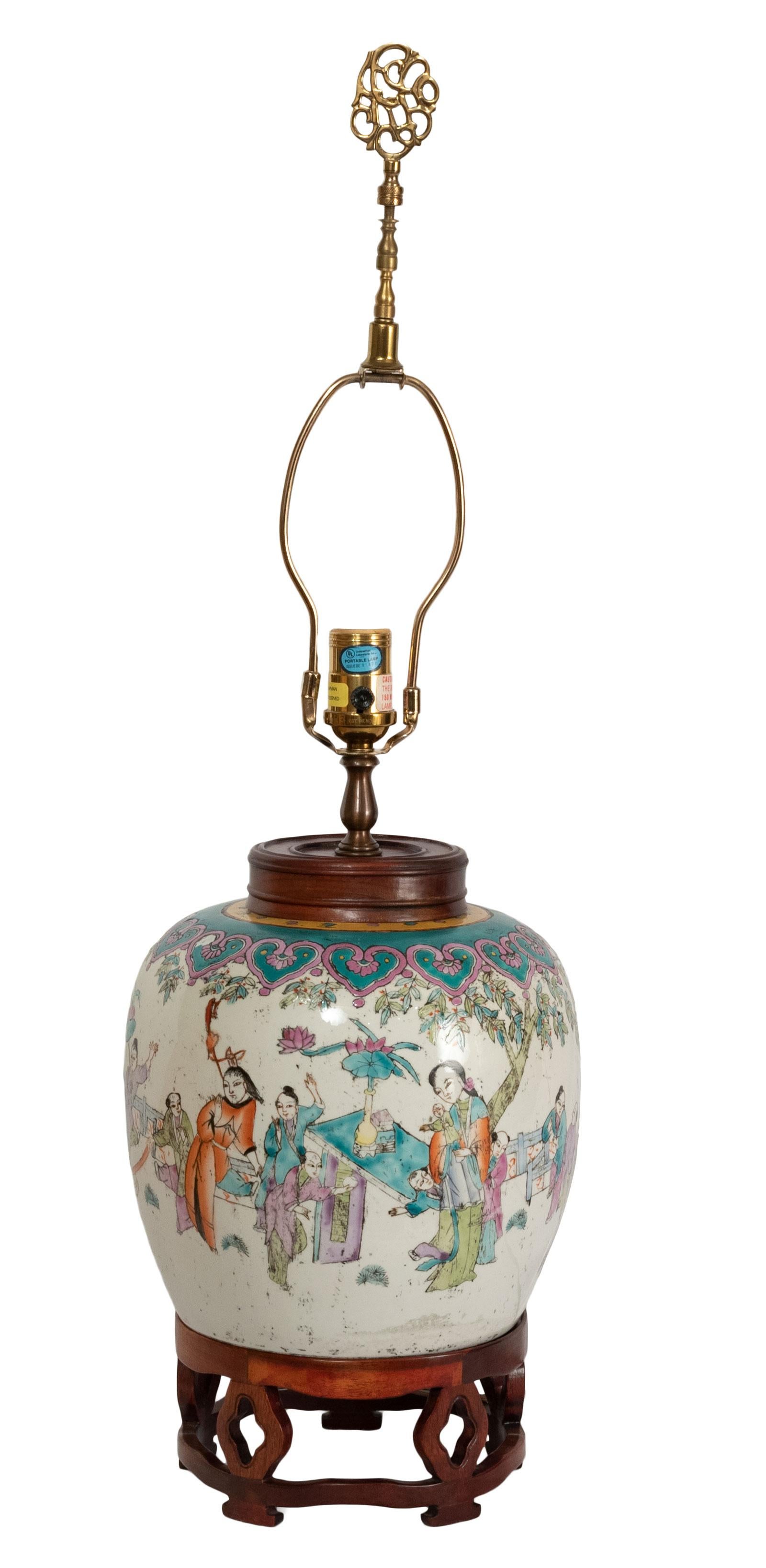 A lamped 19th century Qing dynasty famille rose peach vase with hardwood stand and cover.