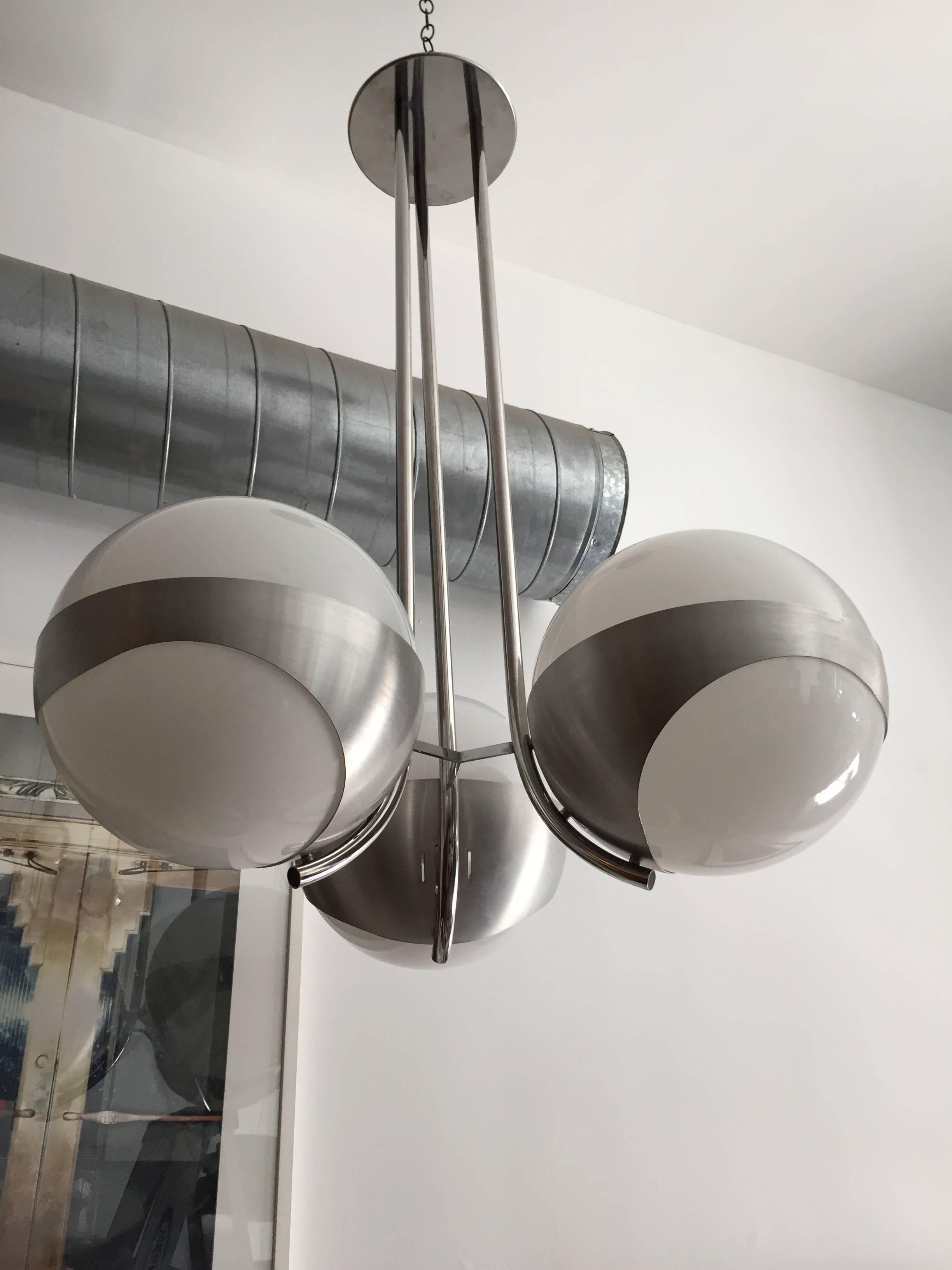 An original Space Age 1970s Italian pendant chandelier composed of brushed and polished steel frame an large white opaline glass globes. Newly rewired. 