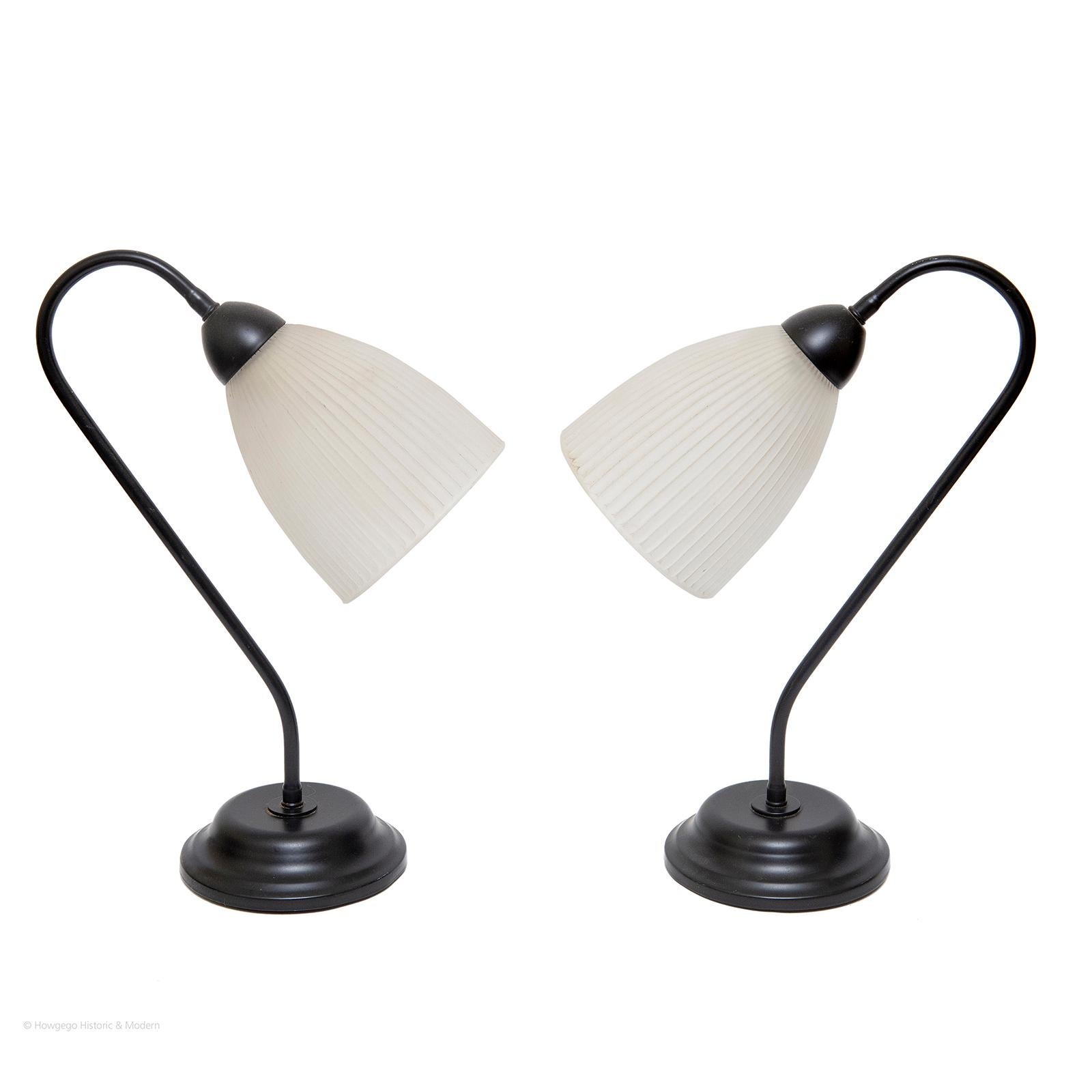 Pair of vintage painted black, metal gooseneck task lamps with original glass shades, 15” high.
Original glass shades
Not adjustable
20th Century conversion to electricity.
Pricing £1,000

Measures: height 38.5cm, 15 inches, 
Base diameter 14