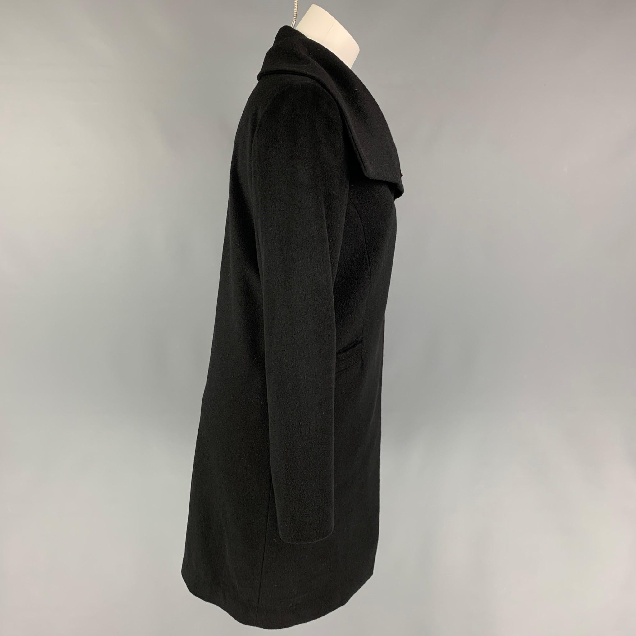 LAN JAENICKE coat comes in a black cashmere featuring a high collar, slit pockets, and a hidden placket closure. 

Very Good Pre-Owned Condition.
Marked: 1
Original Retail Price: $1,695.00

Measurements:

Shoulder: 14.75 in.
Bust: 37 in.
Sleeve: 25