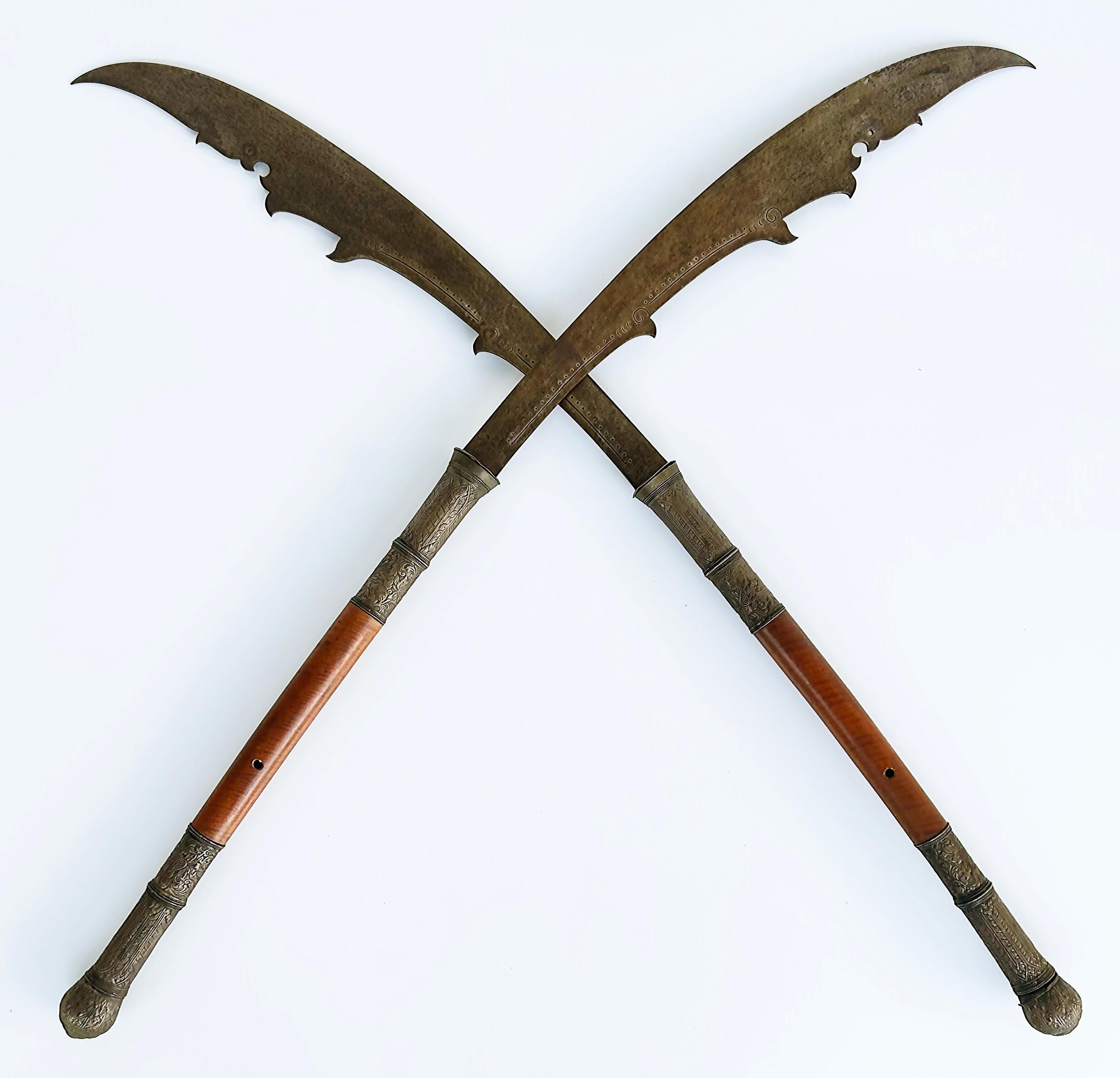 Offered for sale is a pair of 20th-century Lan Na Kingdom Dhaab Ngao Swords from Thailand. They are hand-forged traditional Thai Dhaabs that used ancient techniques that have been passed on for generations. Swords such as these were used while