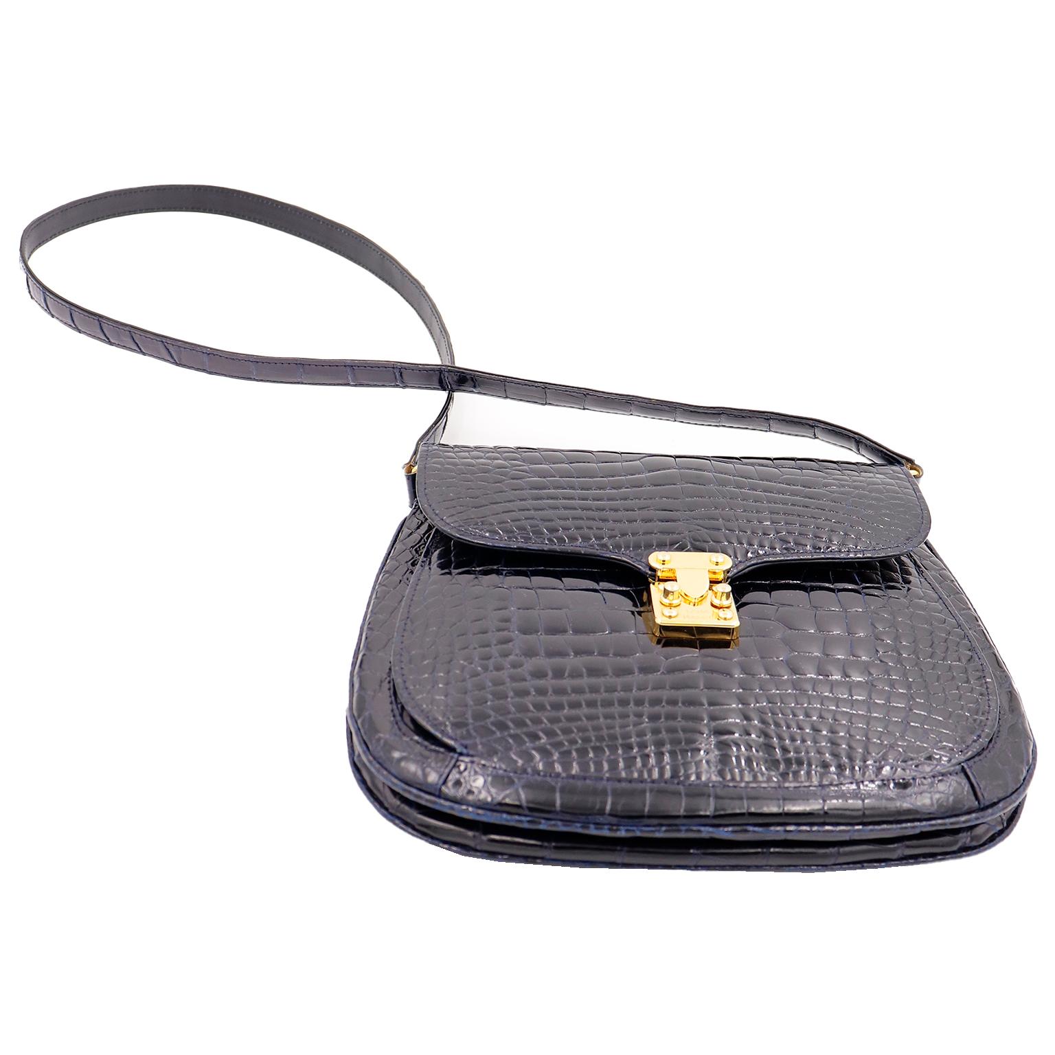This Lana Marks black gloss alligator handbag is the epitome of quiet luxury. The bag has a shoulder strap and a front gold branded lock closure. Luxury bags like these are so elegant and we love bags that define 