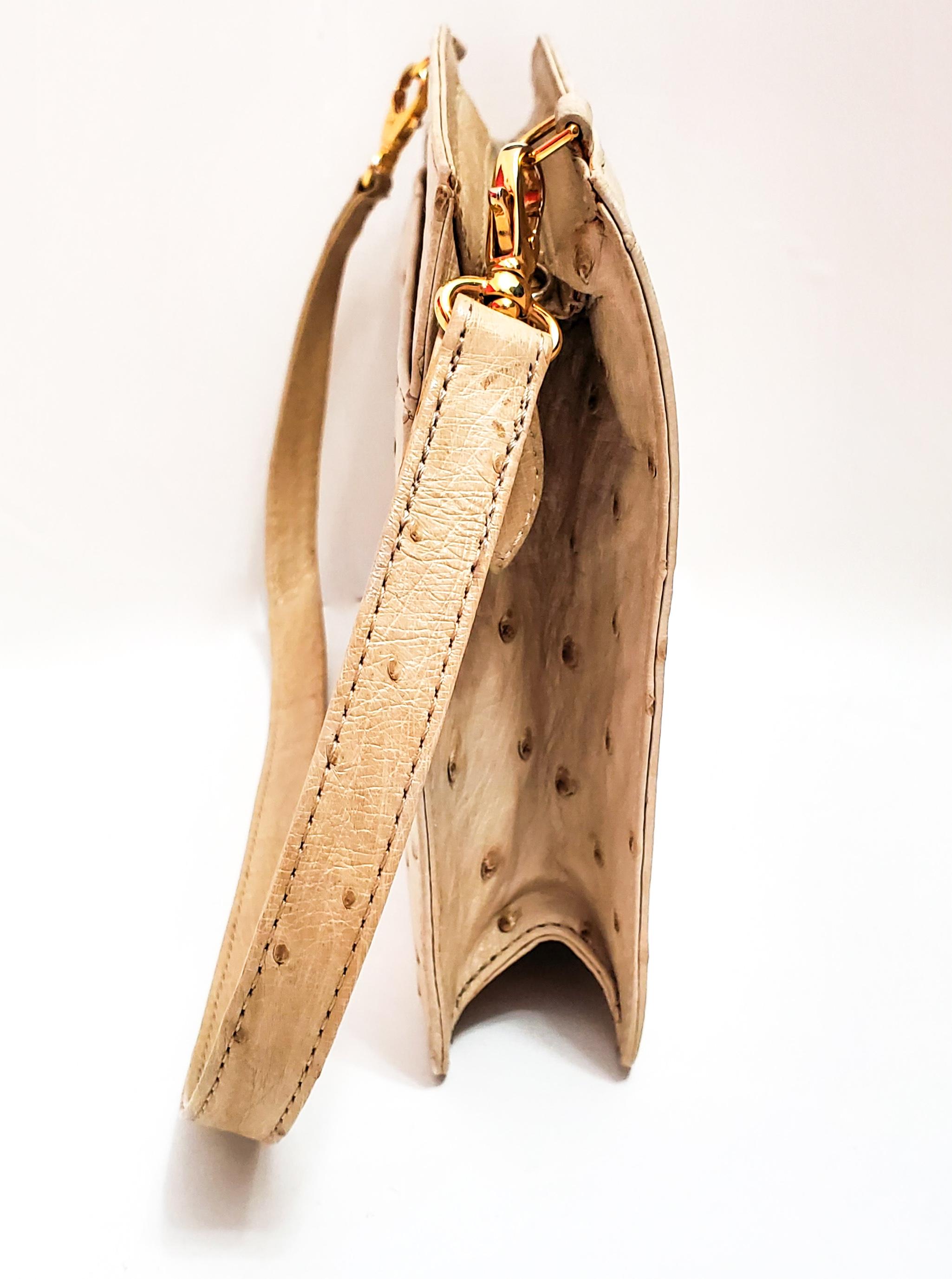 Lana Marks is known world wide for fabulous handbags!  This stunning ostrich bag in cream can be carried as a clutch or use removable shoulder strap for a different look!
Outside snap closure, a side zip pocket with gold tone hardware.  Not limited