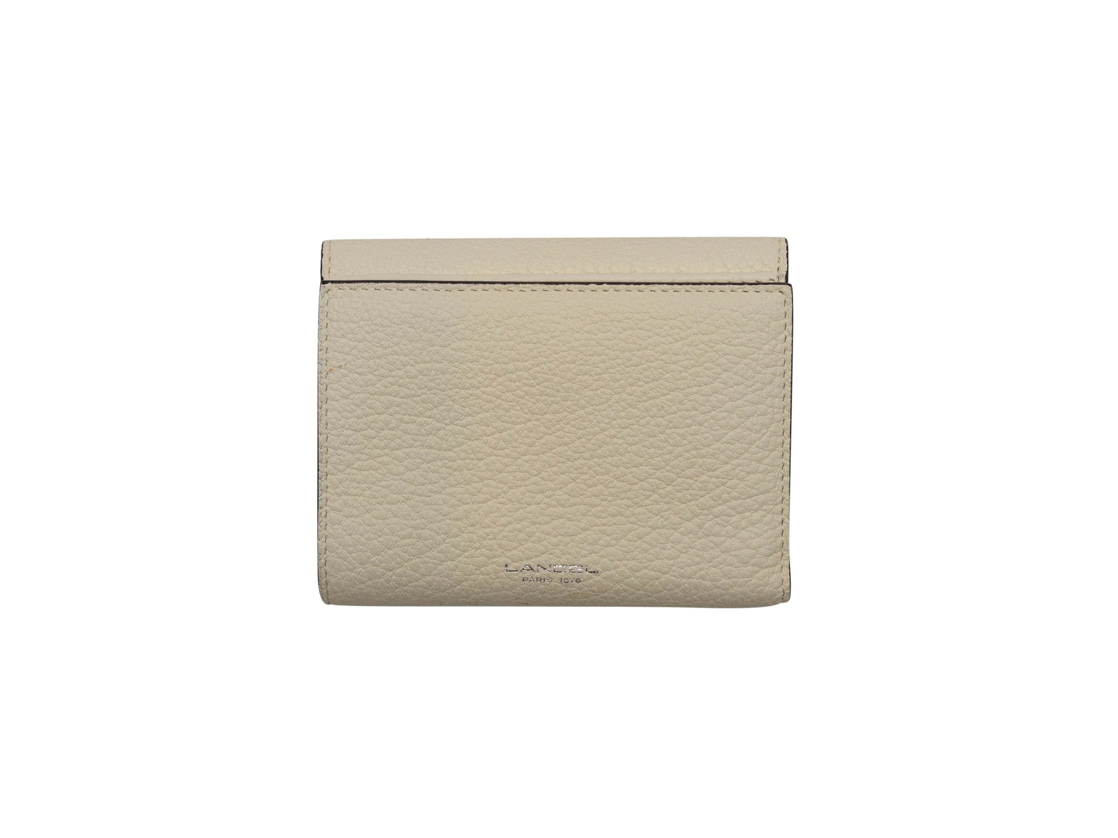 Product details: Beige leather wallet by Lancel. Interior card and cash slots. Snap closure at front. 4