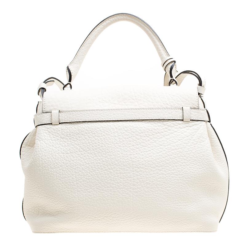 How chic, feminine and elegant does this Charlie De Lancel bag looks! The off-white creation is crafted from grained leather and features a top handle with an attached accent, a shoulder strap, a sturdy bottom and a front flap closure that opens to