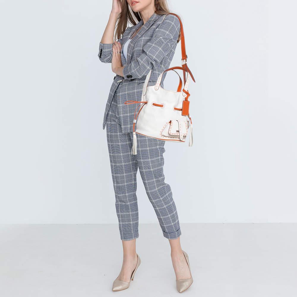 Designed in a bucket silhouette, this Lancel Premier Flirt bag features a white and orange leather body and comes detailed with gold-tone hardware. Apart from dual top handles, this bag also has a shoulder strap to go cross-body for busier days. It