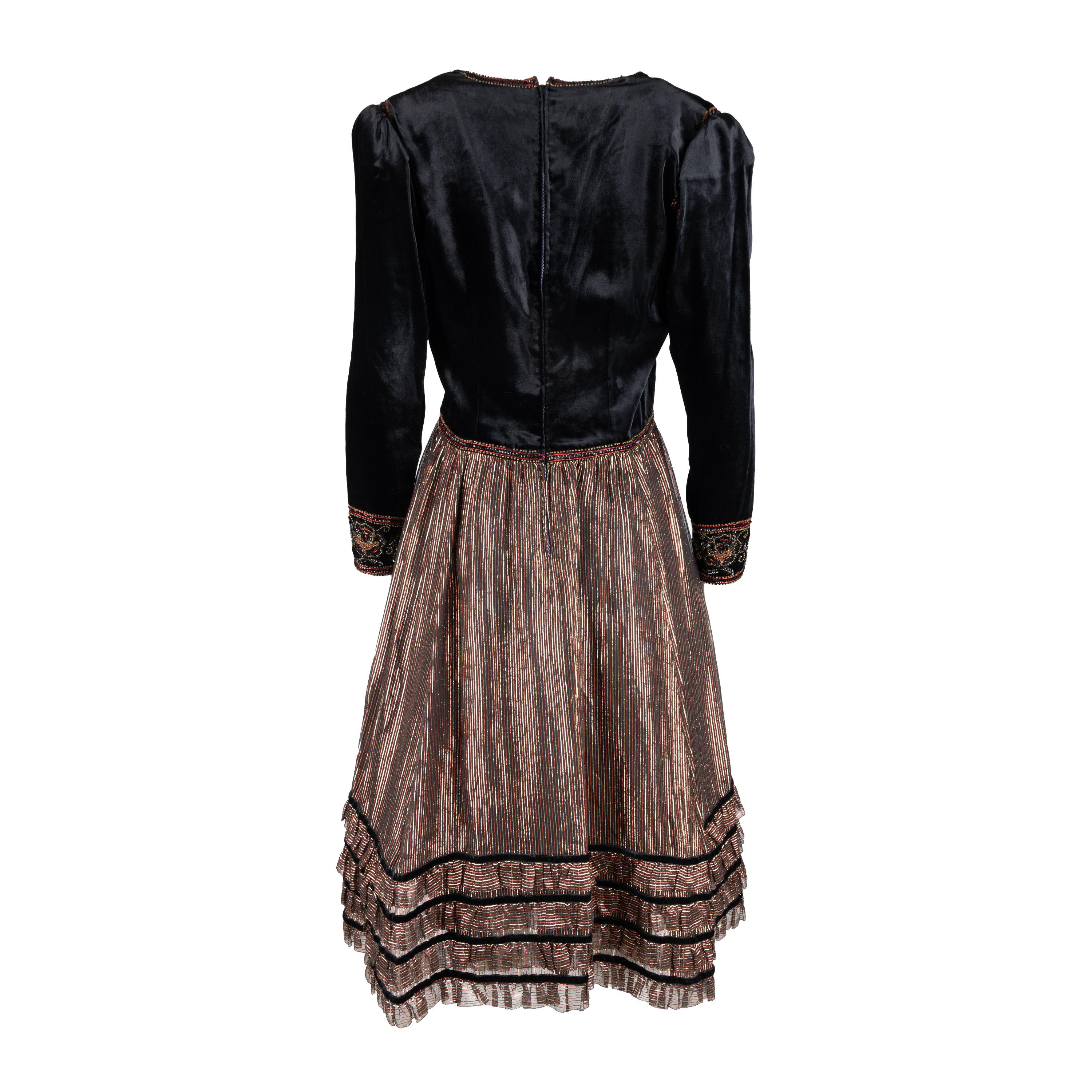 This vintage-style dress from Lancetti is sure to make you feel like the belle of the ball. Crafted using a combination of black velvet and sheer shimmer fabric, it is embellished with multicolor beads, sequins and threads. Its full sleeve and round