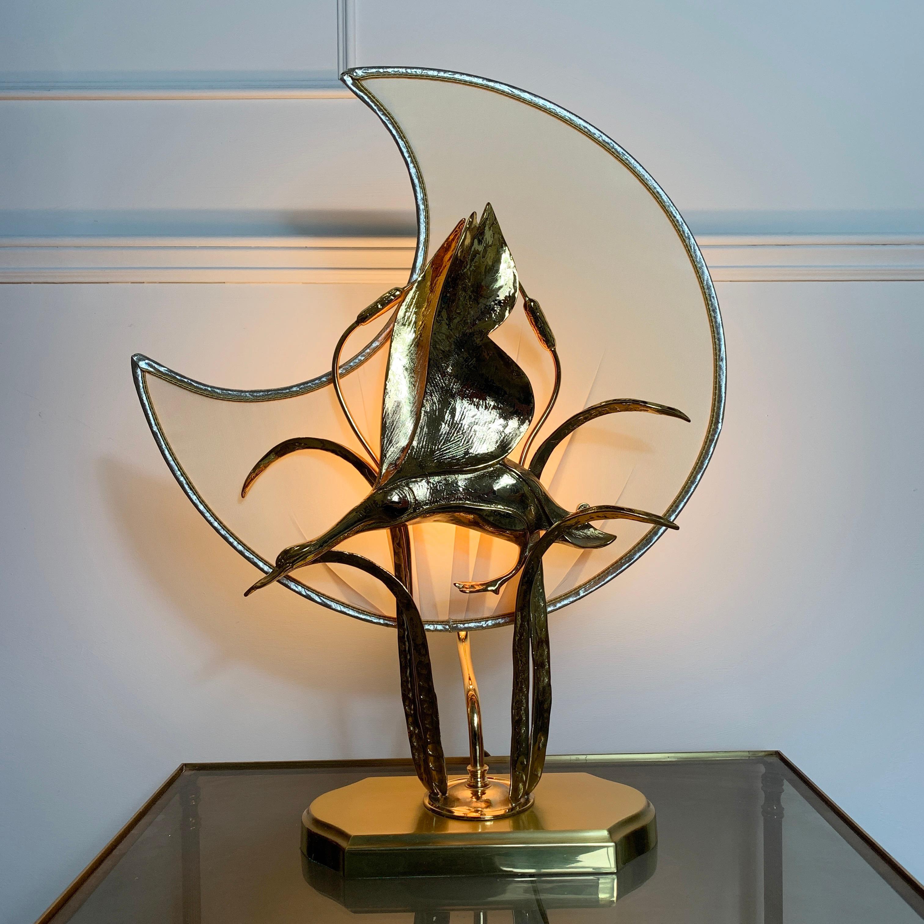 Lanciotto Galeotti, goose and moon table lamp, for Ida Bellini
Vintage gold-plated table lamp depicting a flying goose and bulrushes with a fabulous silken moon shaped shade behind
The goose sculpture is mounted on a brass base, the goose and
